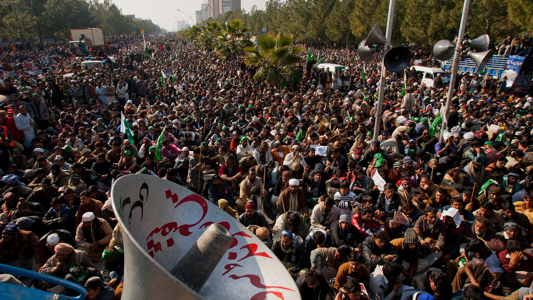 Jan. 15, 2013: Supporters of Pakistani Sunni Muslim cleric Tahir-ul-Qadri listen to a speech by ul-Qadri, unshown, at an anti-government rally in Islamabad, Pakistan.