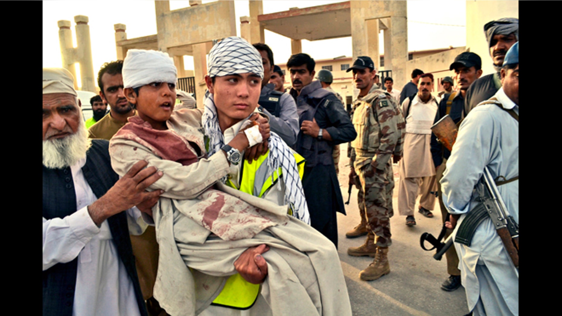 June 15, 2013: A Pakistani boy who was injured by gunmen is carried to a vehicle outside a hospital in Quetta, Pakistan. Gunmen took over parts of a hospital in southwestern Pakistan Saturday after a bomb went off inside its emergency room, officials said.