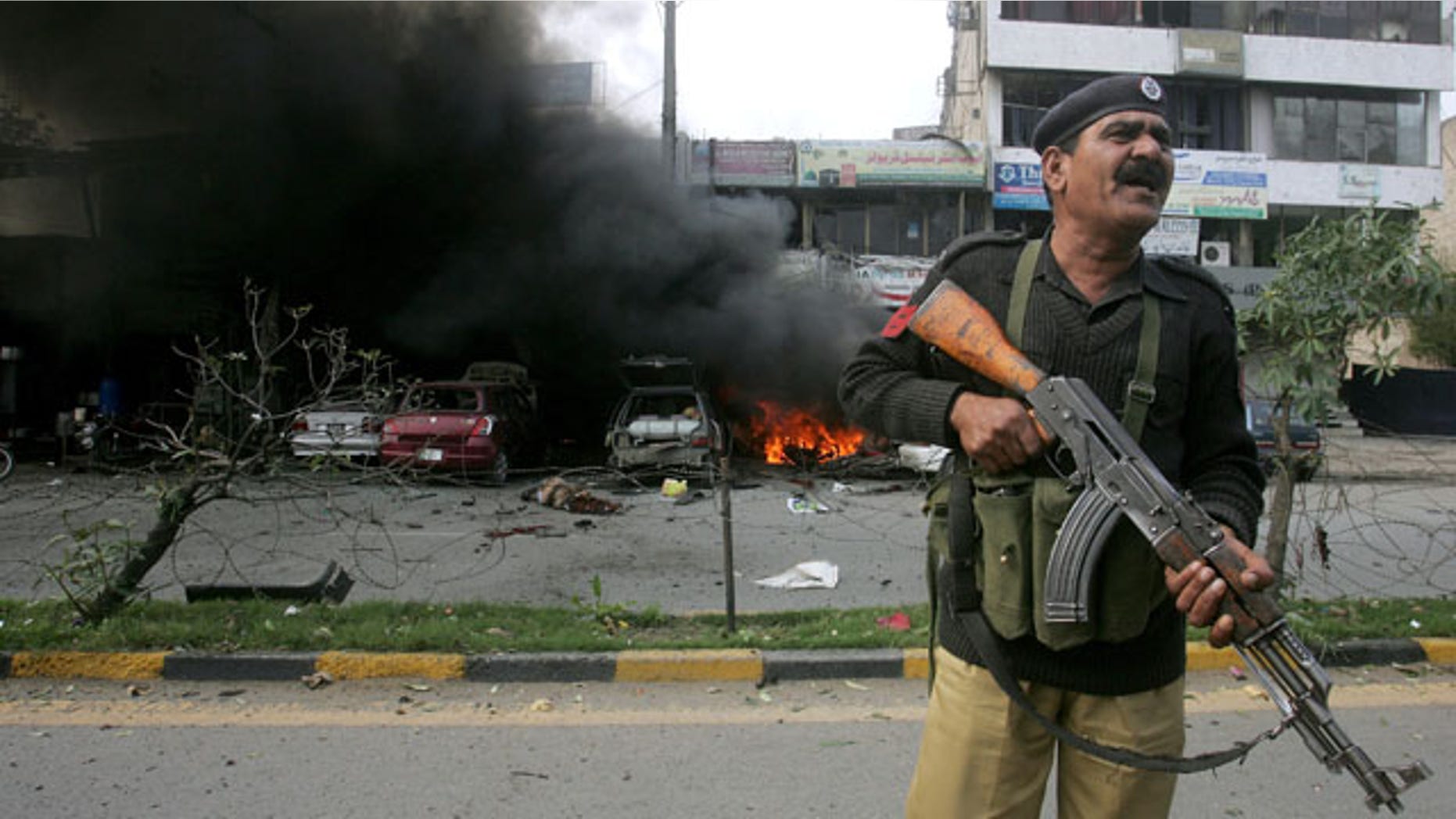 Feb. 17, 2015: A Pakistani police officer stands guard at the site of a bombing in Lahore. (AP Photo/K.M. Chaudary)