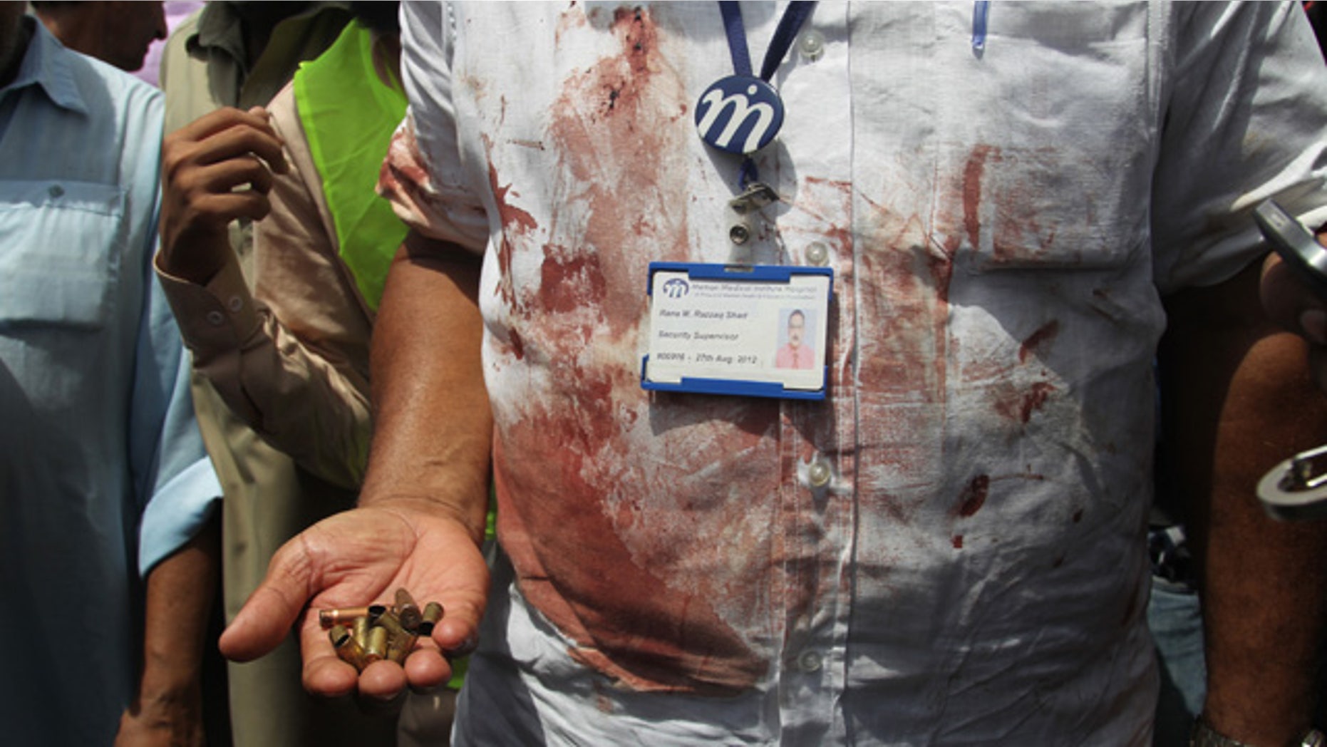 May 13, 2015: A Pakistani security official displays cartridges he collected from the scene of an attack on a bus in Karachi. Gunmen killed dozens of people on Wednesday aboard a bus in southern Pakistan bound for a Shiite community center, in the latest attack targeting the religious minority, police said. (AP Photo/Fareed Khan)