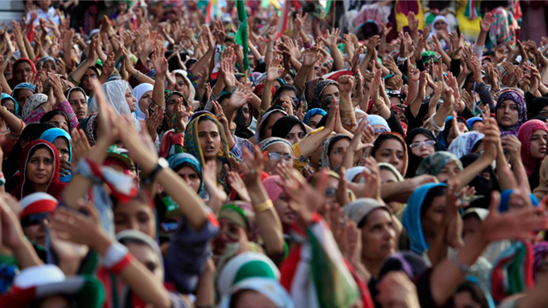 August 17, 2014: Supporters of Pakistan's fiery anti-government cleric Tahir-ul-Qadri praise their leader at a rally in Islamabad. Pakistan's cricketer-turned-politician Imran Khan and Qadri led massive rallies in Pakistan's capital, demanding Prime Minister Nawaz Sharif step down over alleged fraud in last years election in front of thousands of protesters. (AP Photo/Anjum Naveed)
