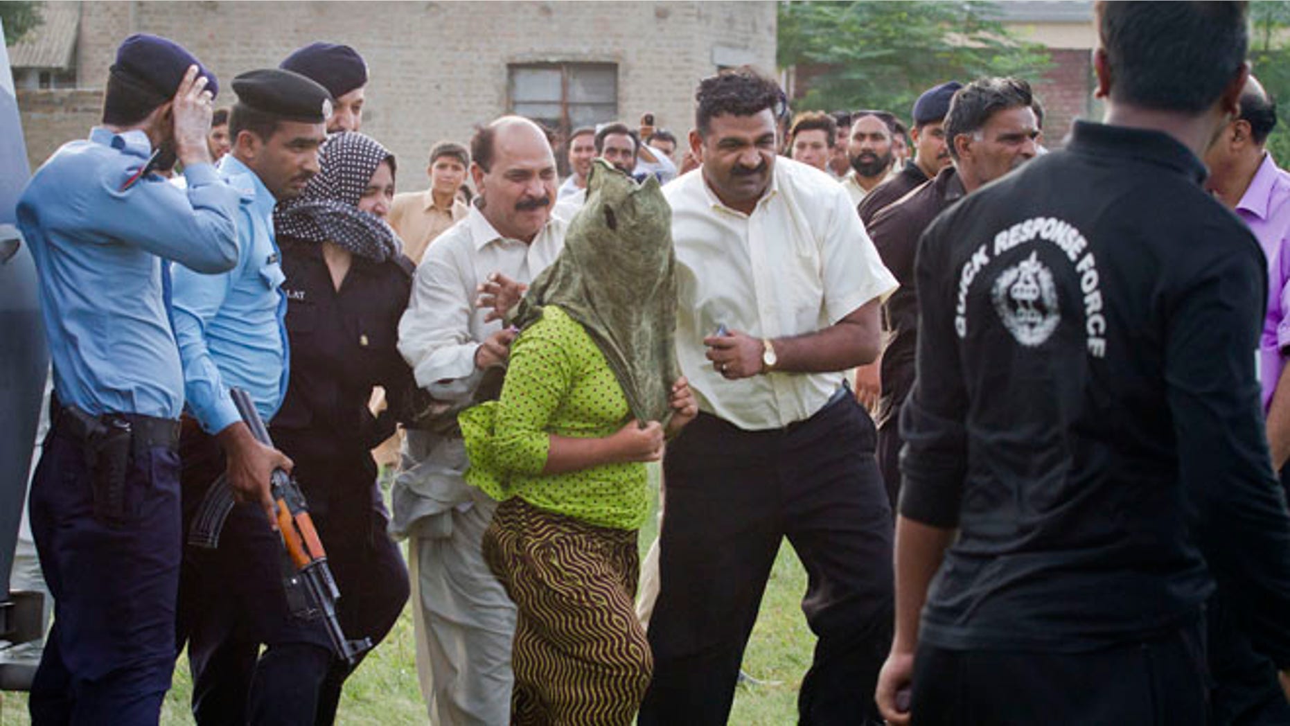 Sept. 8: Pakistani police officials escort a young Christian girl, center, accused of blasphemy for allegedly burning pages of a Quran, toward a helicopter following her release from central prison on the outskirts of Rawalpindi, Pakistan.