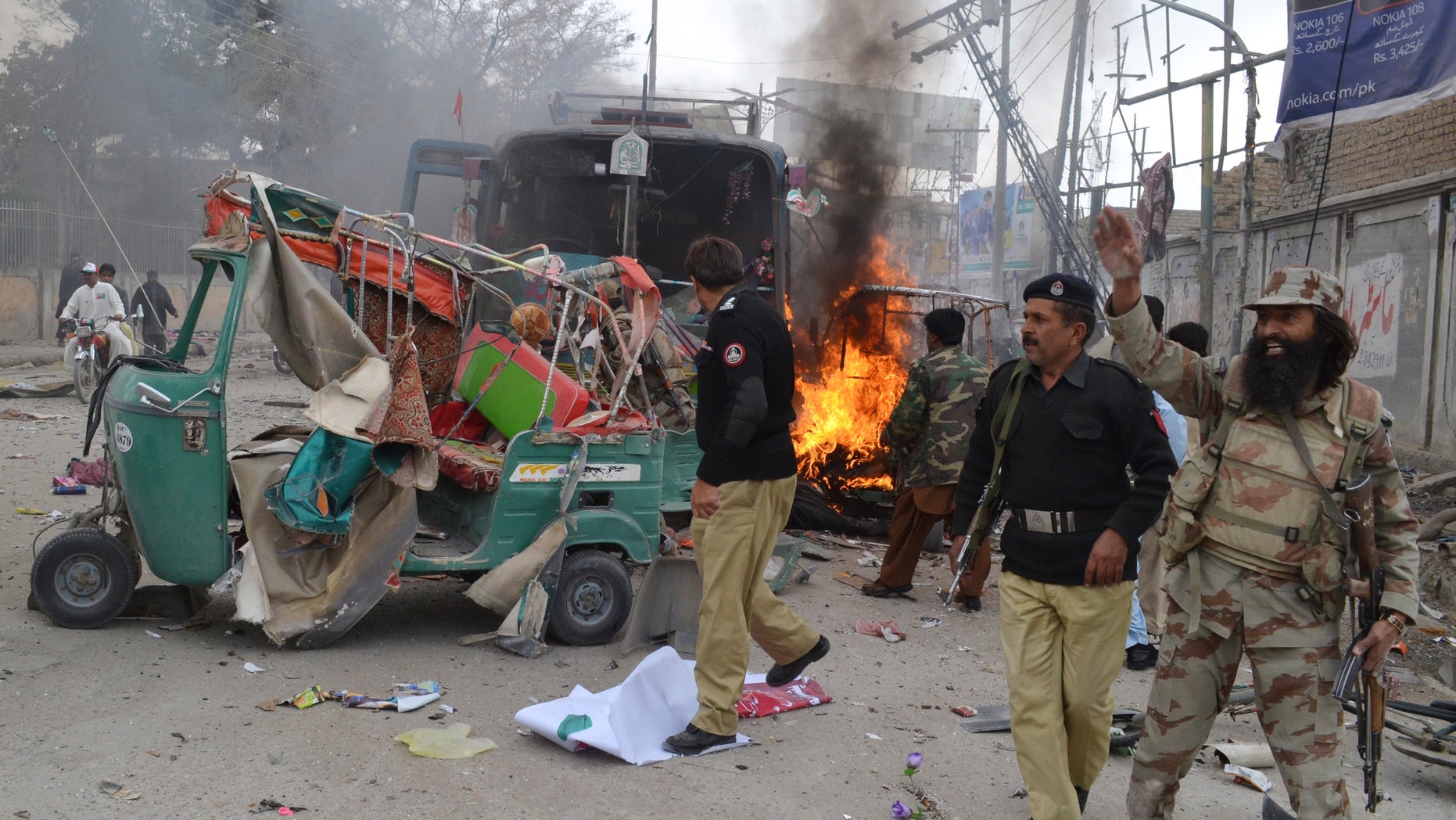 March 14, 2014 - A soldier of the Pakistani paramilitary force shouts for help following a blast in Quetta, Pakistan. A doctor at a hospital in southwestern Pakistan said nearly a dozen people were killed when a bomb went off near a passenger bus in the city of Quetta.