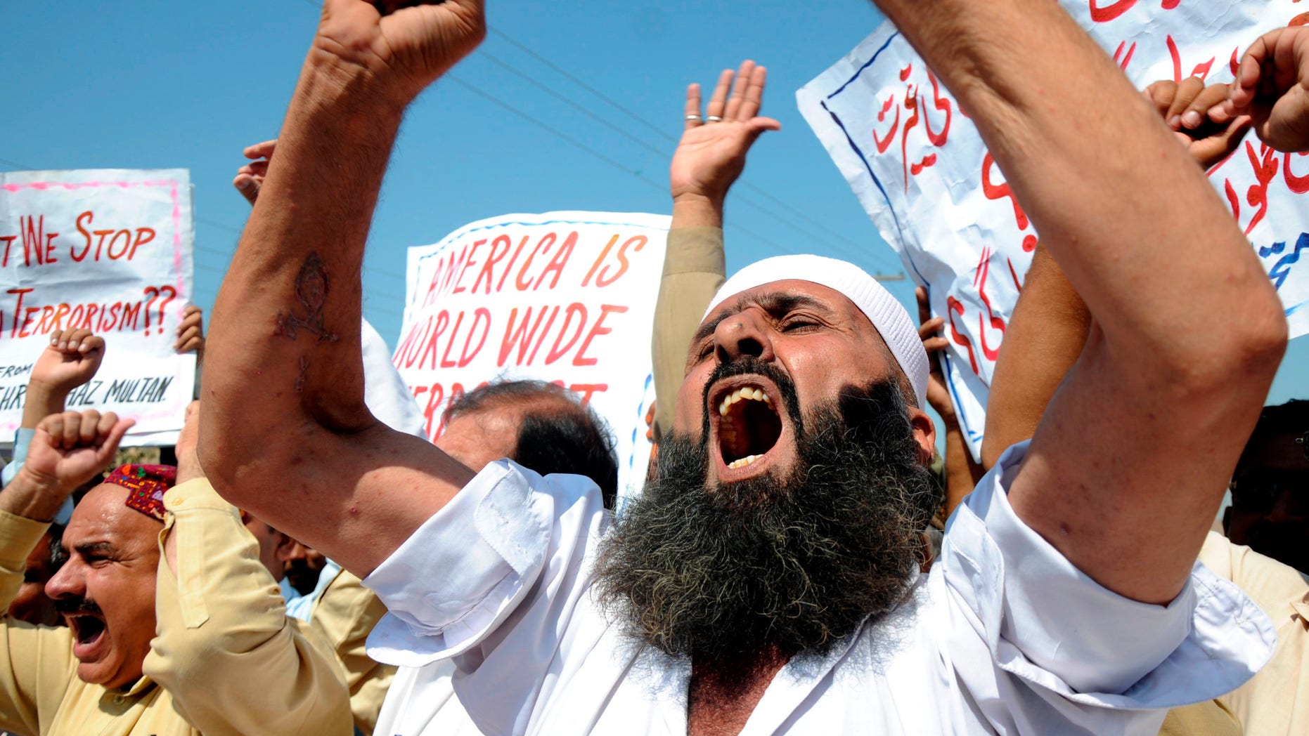 People shout anti-American slogans at a rally to condemn U. S. strikes on militants' hideouts in Pakistani tribal areas, in Multan, Pakistan on Friday, Oct 14, 2011.