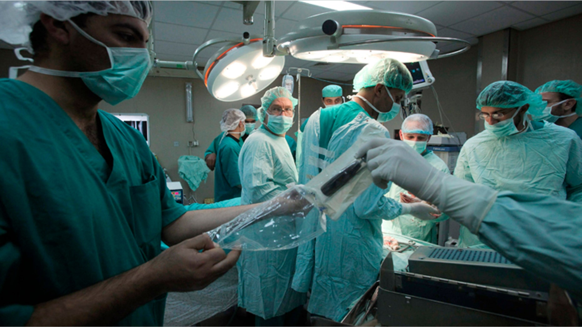 French surgeon Christopher Bulstrode (2nd L) operates on a Palestinian patient as he trains Palestinian doctors in surgical procedures at the Nasser hospital in Khan Younis in the southern Gaza Strip.