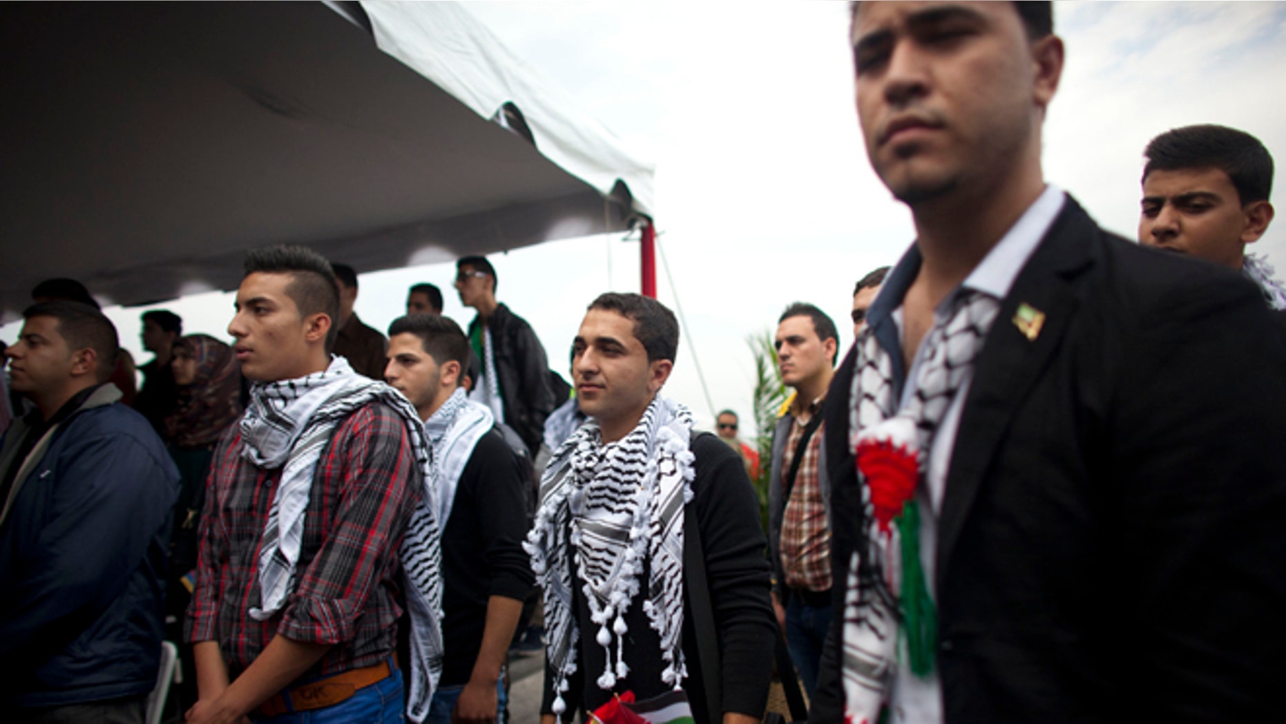 FILE - In this Nov. 6, 2014 file photo, Palestinian students attend a welcome ceremony at the Simon Bolivar airport in Maiquetia, Venezuela. The Palestinian students were greeted like celebrities upon arrival in Caracas. President Nicolas Maduro played up their symbolic importance during an address broadcast across the country. But eight months later, about a third of the Palestinians have dropped out, complaining that the program lacks academic rigor, according to interviews conducted with students, teachers and government officials. (AP Photo/Ariana Cubillos, File)