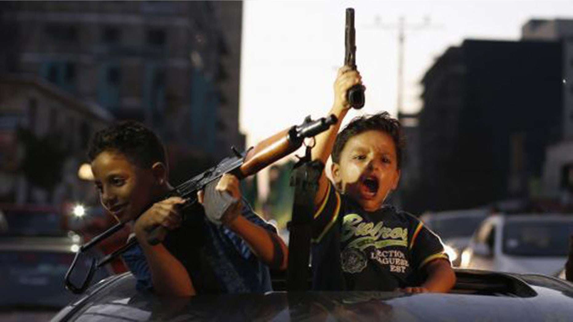 August 26, 2014: Palestinian children hold guns as they celebrate what Hamas claimed was a victory over Israel, following a ceasefire in Gaza City. (Reuters/SUHAIB SALEM)