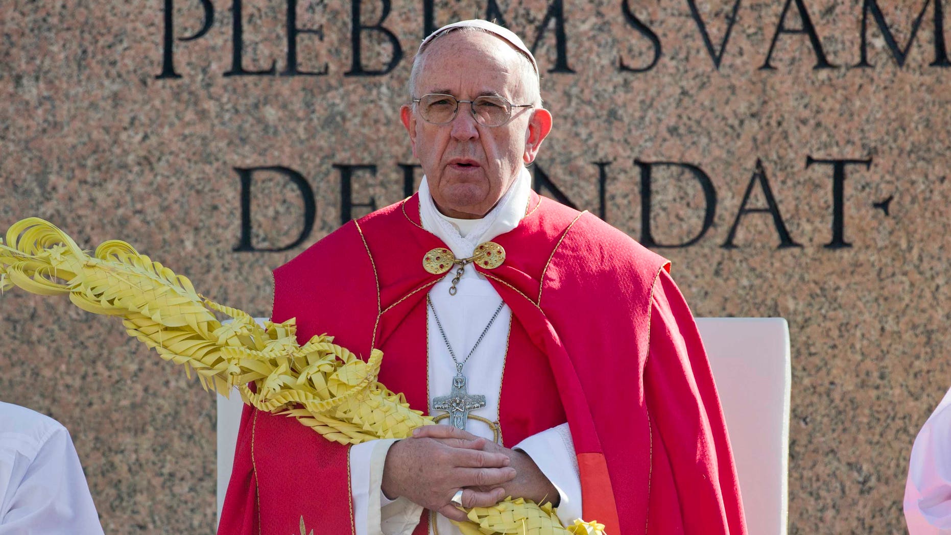Pope Francis holds a palm leaf as he celebrates Palm Sunday Mass, in St. Peter's Square, at the Vatican, Sunday, March 20, 2016. (AP Photo/Alessandra Tarantino)