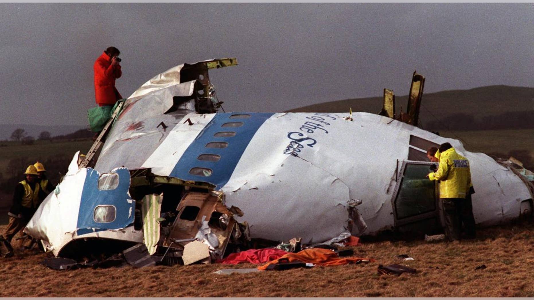 Police and investigators look at what remains of the flight deck of Pan Am 103 on a field in Lockerbie, Scotland in this Dec 22, 1988 file photo . (AP Photo/File)