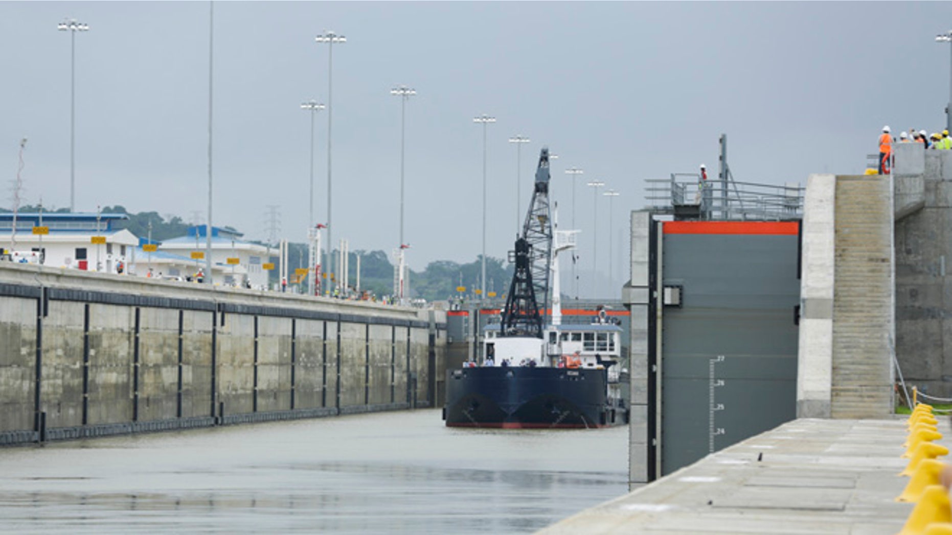 A Panama Canal Authority crane ship Oceanus, navigates the Cocoli locks during a test of the newly expanded Panama Canal locks on Pacific side, in Cocoli, Panama, Monday, June 20, 2016. The canal's expansion project will be officially inaugurated on June 26. (AP Photo/Arnulfo Franco)