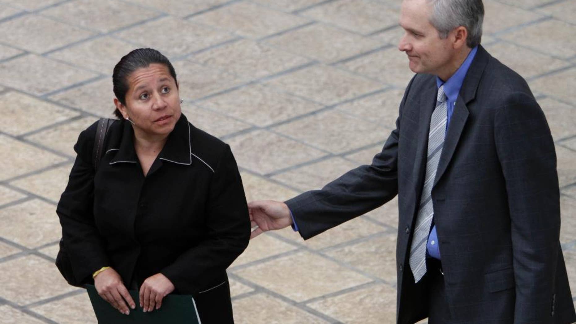 FILE - In this Nov. 22, 2010 file photo, Panama's Deputy Foreign Minister Alvaro Aleman, right, accompanies Maria del Pilar Hurtado, former head of Colombia's domestic intelligence agency, as she leaves the foreign ministry building, in Panama City. After several years on the run the ex-spy chief surrendered to authorities in Panama, Friday, Jan. 30, 2015, to face charges of spying on opponents of Colombia's former President Alvaro Uribe. She’s now being held at the chief prosecutor’s office in Colombia awaiting arraignment. (AP Photo/Arnulfo Franco, File)