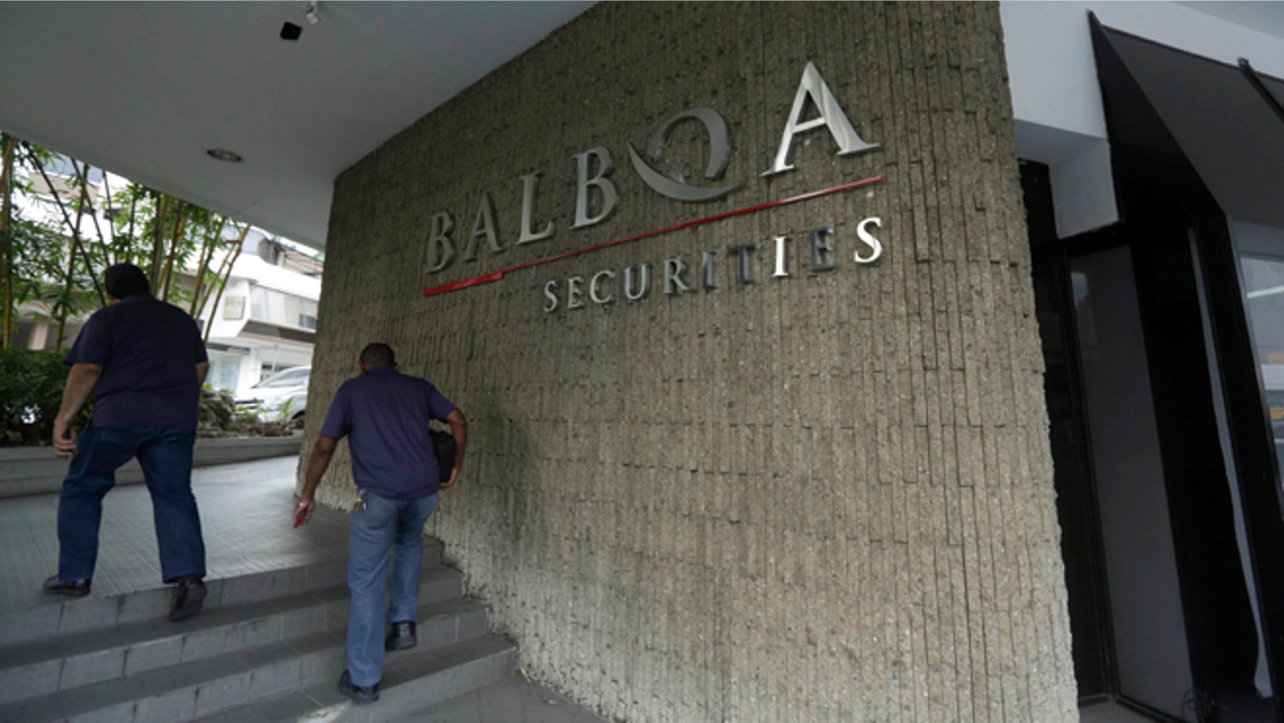 People walk outside the Balboa Bank & Trust Corp. building in Panama City, Thursday, May 5, 2016.