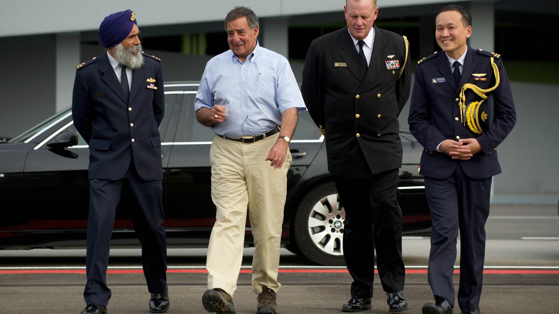 June 3, 2012: U.S. Secretary of Defense Leon Panetta, second from left, walks with Commander Air Power Generation Command Col. Sarbjit Singh, left, Defense and Naval Attache for Singapore Capt. John Wood, second from right, and Singapore Defense Attache to the U.S. Brig Gen. Chee Wee Tan before departing Paya Lebar Airfeild, Singapore.