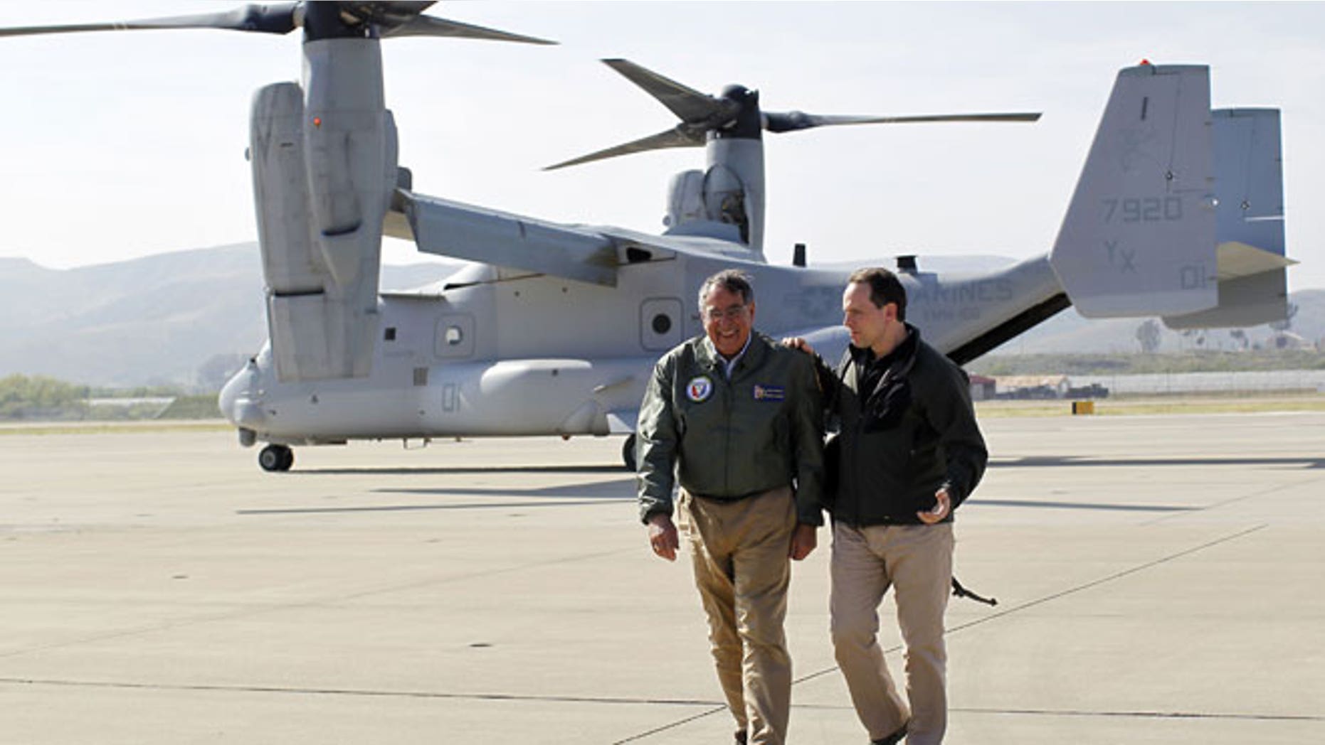 In this March 30, 2012 file photo, U.S. Secretary of Defense Leon Panetta, left, talks with his chief of staff Jeremy Bash after landing in an V-22 Osprey at Camp Pendleton, Calif. Recent crashes involving the U.S. military's latest transport aircraft are fueling an uproar in Japan that could threaten plans to deploy them to the southern island of Okinawa by the end of the year.