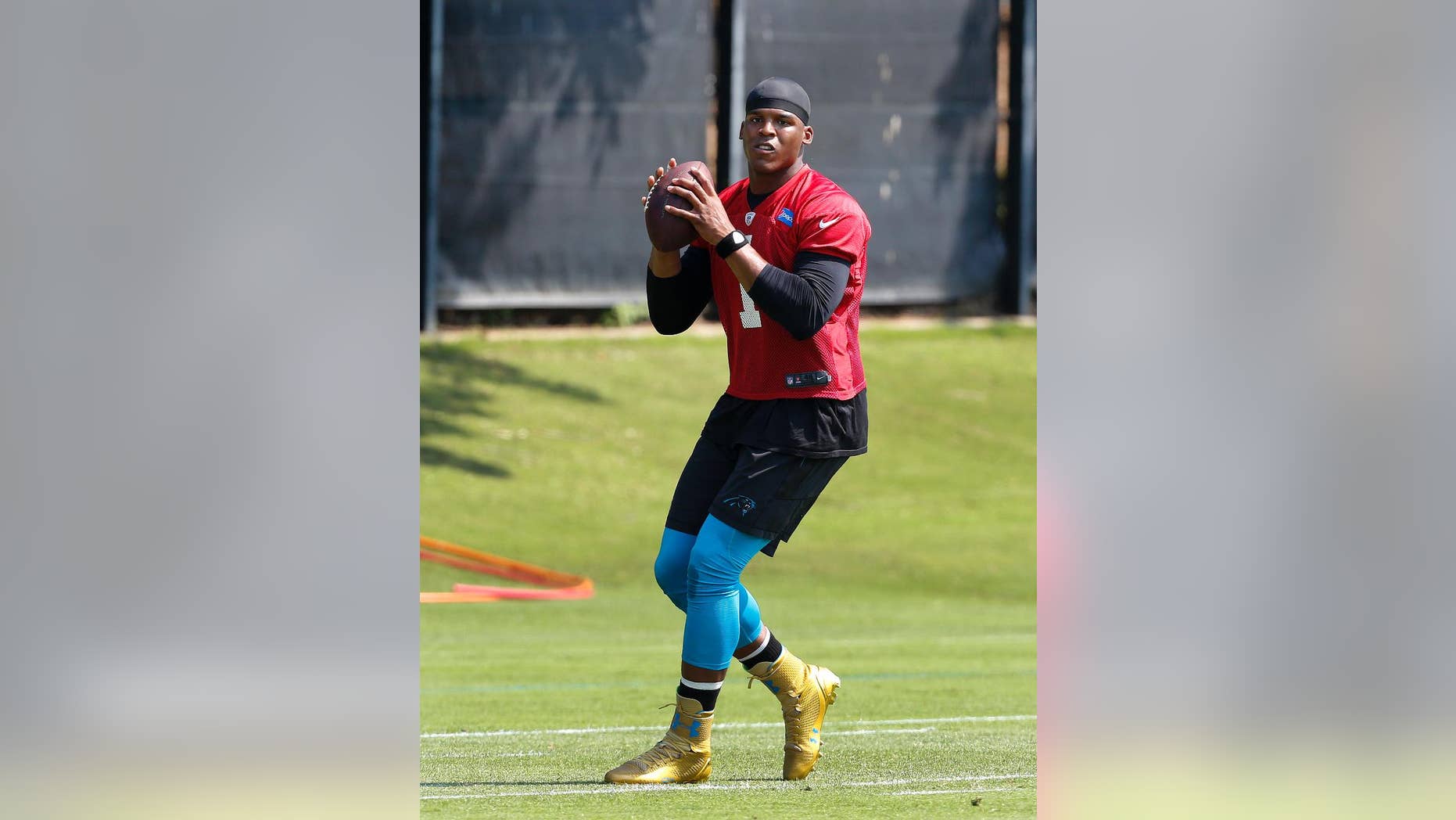 FILE - In this June 17, 2014 file photo, Carolina Panthers quarterback Cam Newton throws a pass during NFL football practice in Charlotte, N.C. Panthers coach Ron Rivera is expected to give an update on Newton's ankle on Thursday, July 24, 2014,one day before the team takes the field for the start of training camp. (AP Photo/Nell Redmond, File)