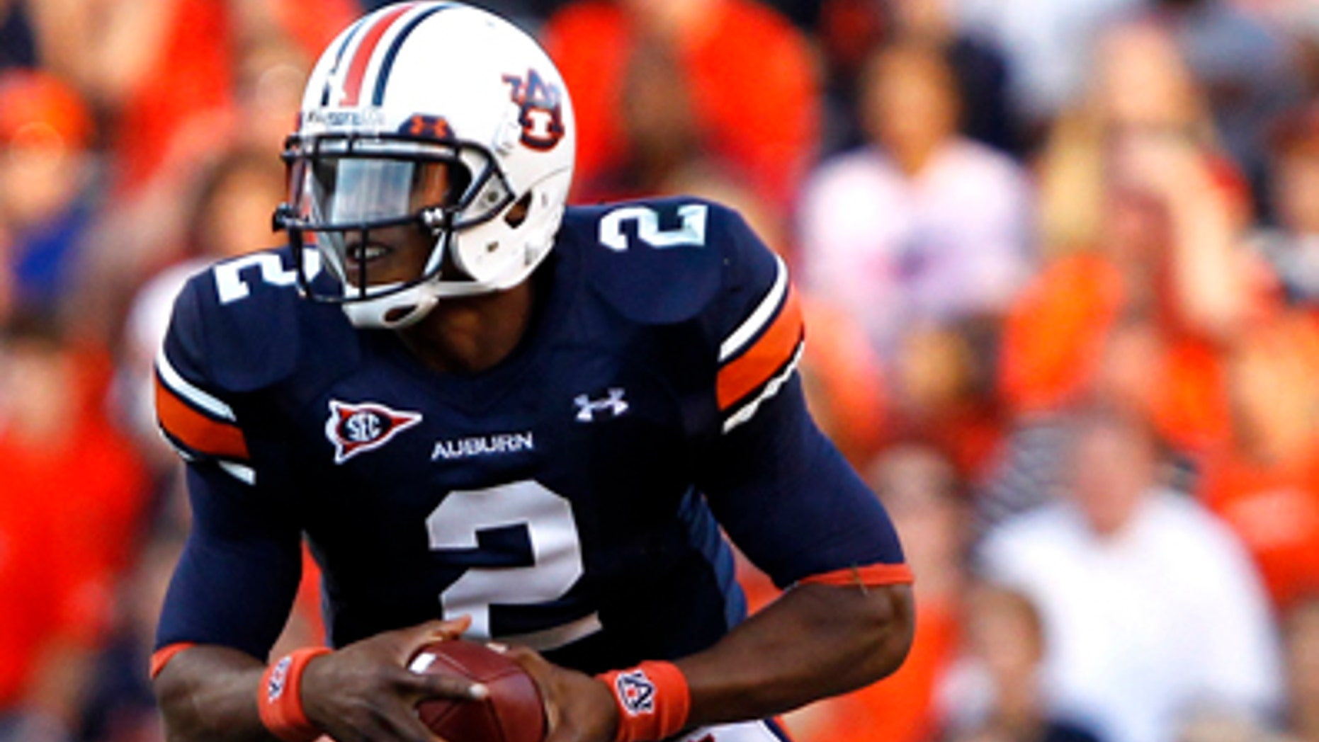 In this Sept. 4, 2010, file photo, Auburn quarterback Cameron Newton (2) runs for a first down against Arkansas State during an NCAA college football game in Auburn, Ala. (AP/File)