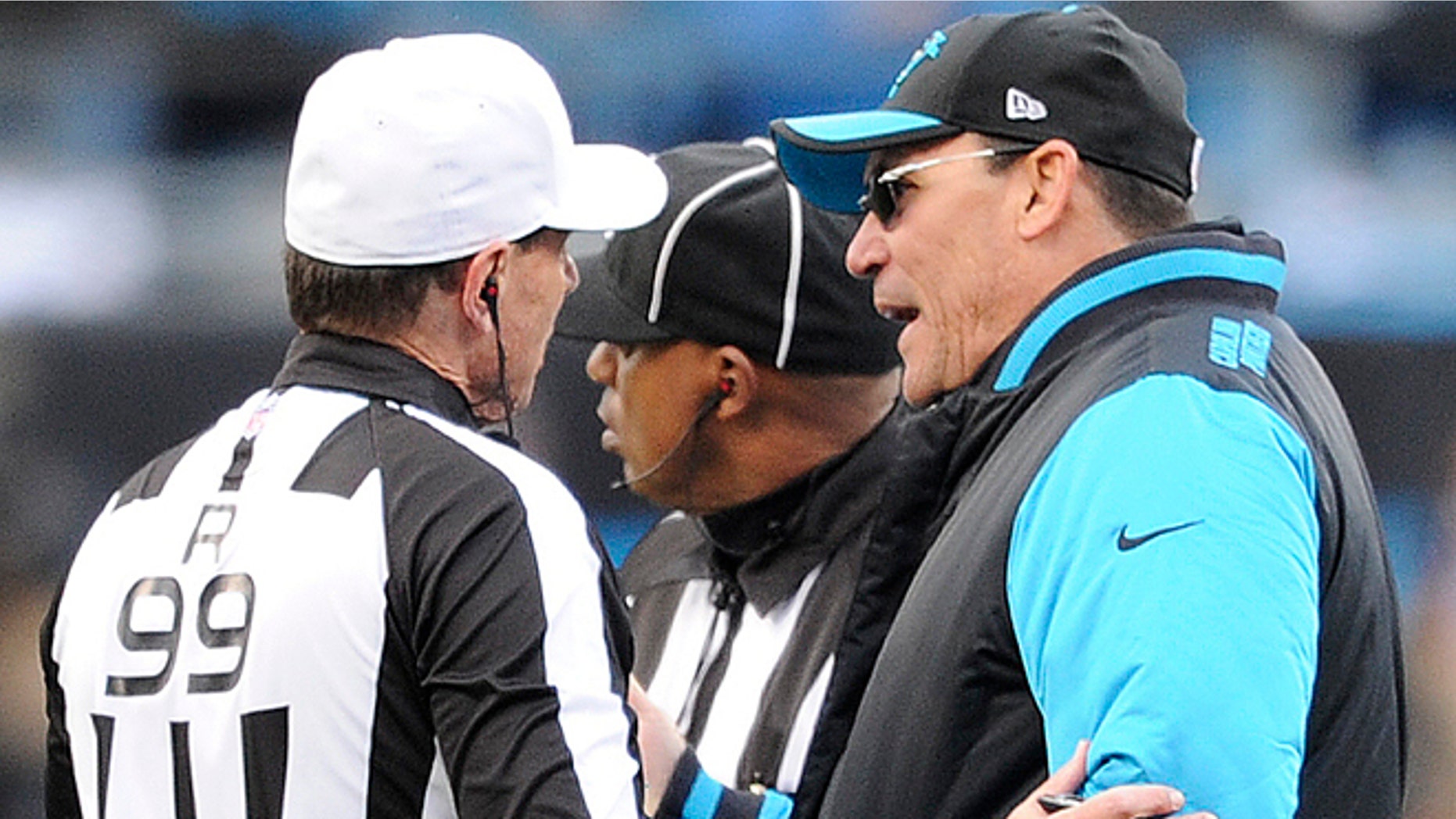 Carolina Panthers head coach Ron Rivera speaks to referee Tony Corrente (99) during the second half of an NFL divisional playoff football game against the Seattle Seahawks, Sunday, Jan. 17, 2016, in Charlotte, N.C. (AP Photo/Mike McCarn)