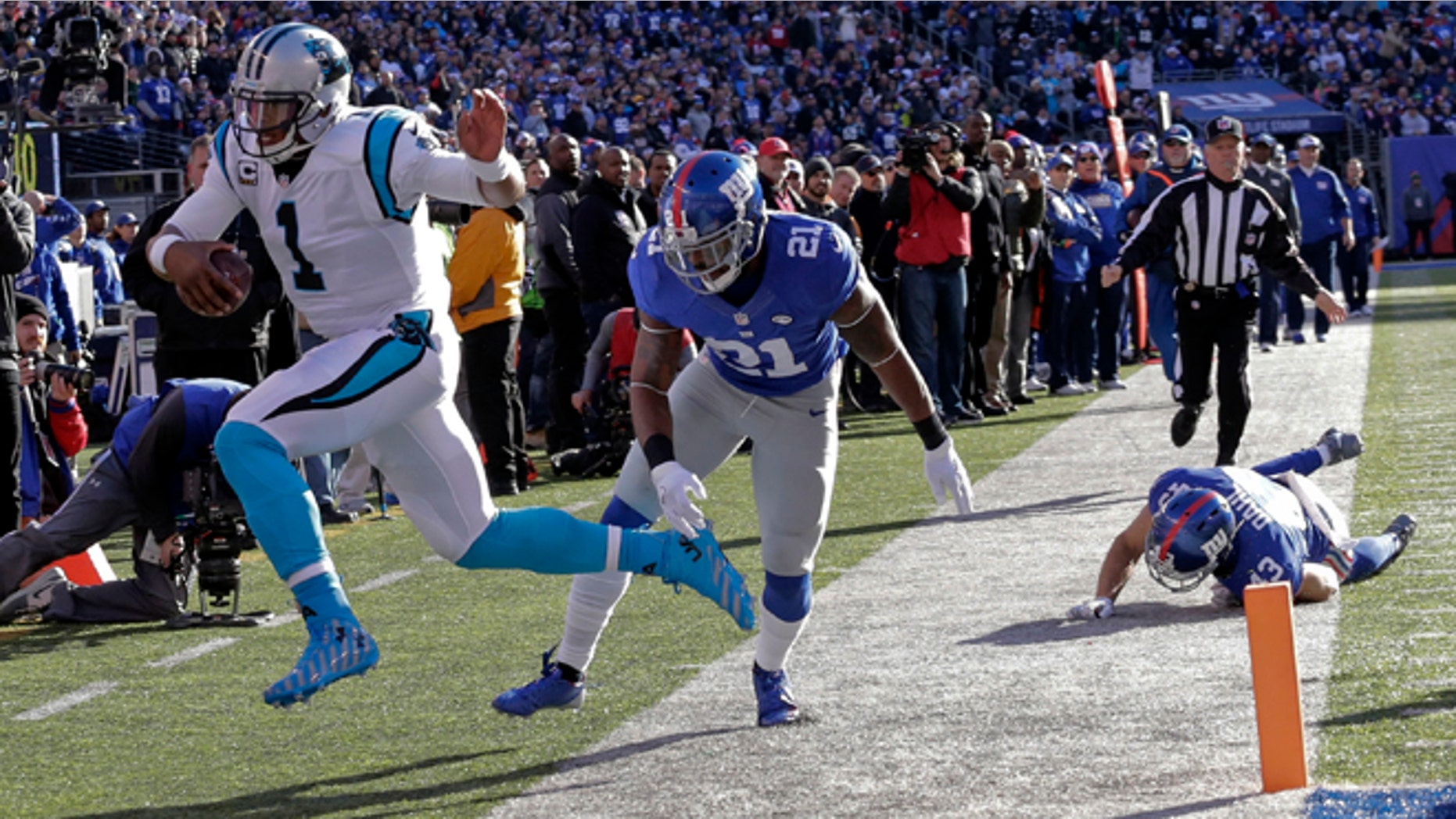 Carolina Panthers quarterback Cam Newton (1) is forced out of bounds by New York Giants' Landon Collins (21) during the first half of an NFL football game Sunday, Dec. 20, 2015, in East Rutherford, N.J. (AP Photo/Julie Jacobson)