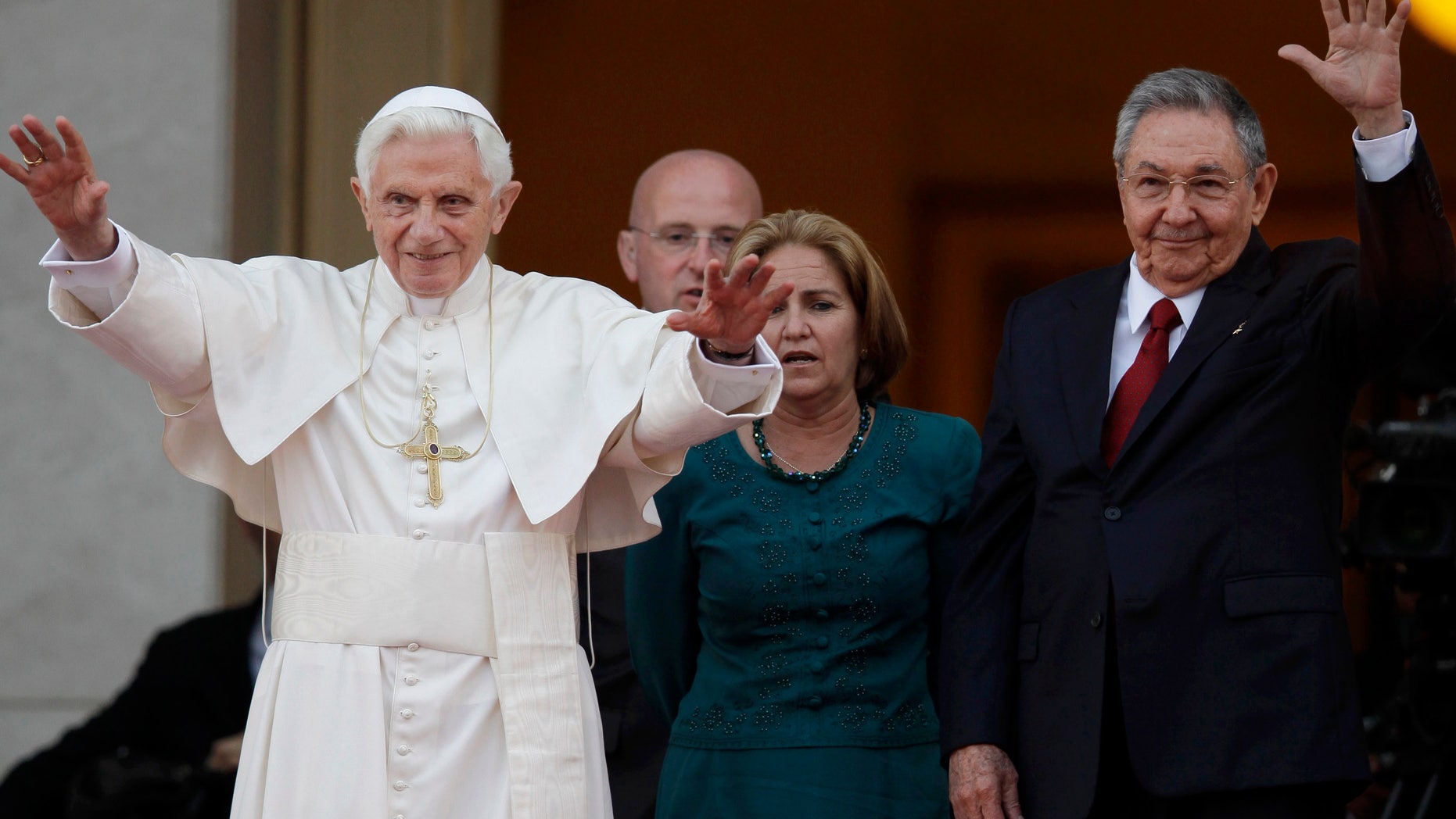Pope Benedict XVI and Cuban President Raul Castro walk outside the Revolution palace at the end of their meeting in Havana, Tuesday, March 27, 2012. The meeting took place behind closed doors on the pontiff's second day on the island.(AP Photo/Javier Galeano)