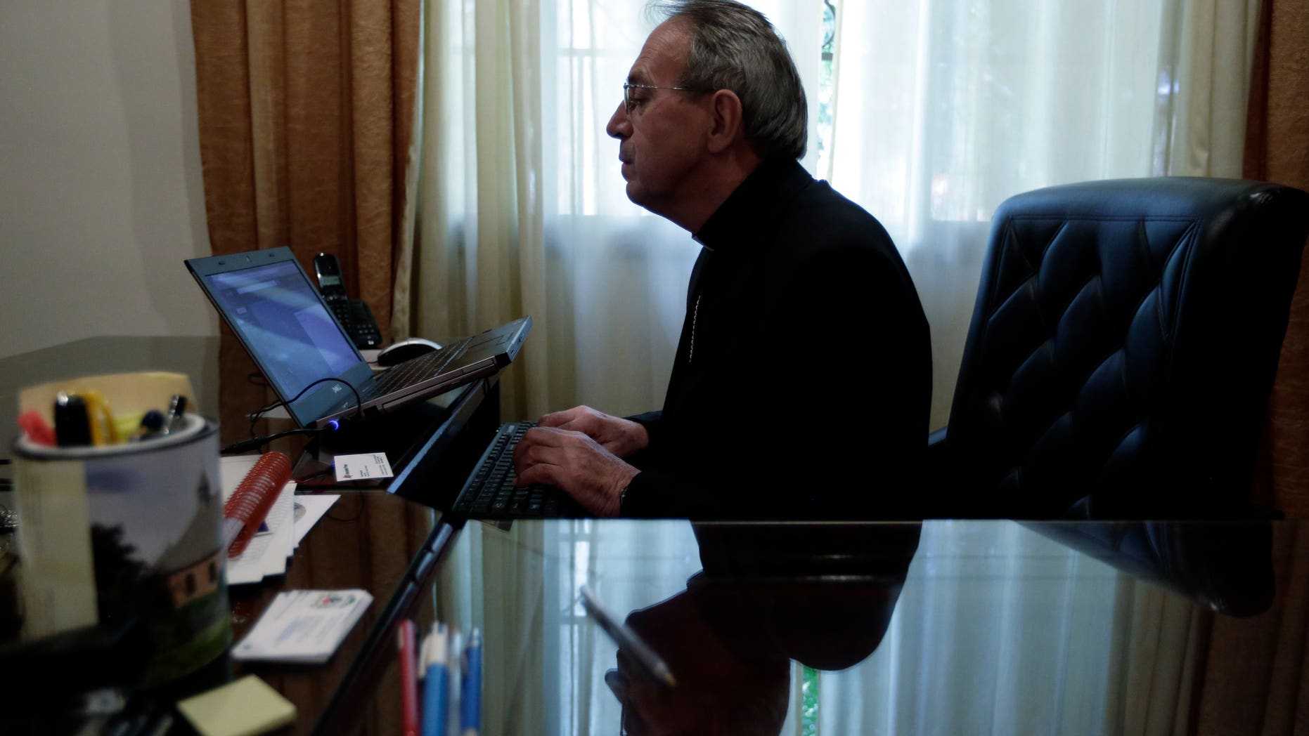 In this May 14, 2015 photo, Bishop Guillermo Steckling, of Germany, at work in Paraguay's Ciudad del Este's diocesis. Steckling, who took over the diocese five months ago, acknowledged he had discovered several accounting irregularities from his predecessor. However, he ruled out pushing for criminal charges, arguing the diocese needed healing after years of divisions. (AP Photo/Jorge Saenz)