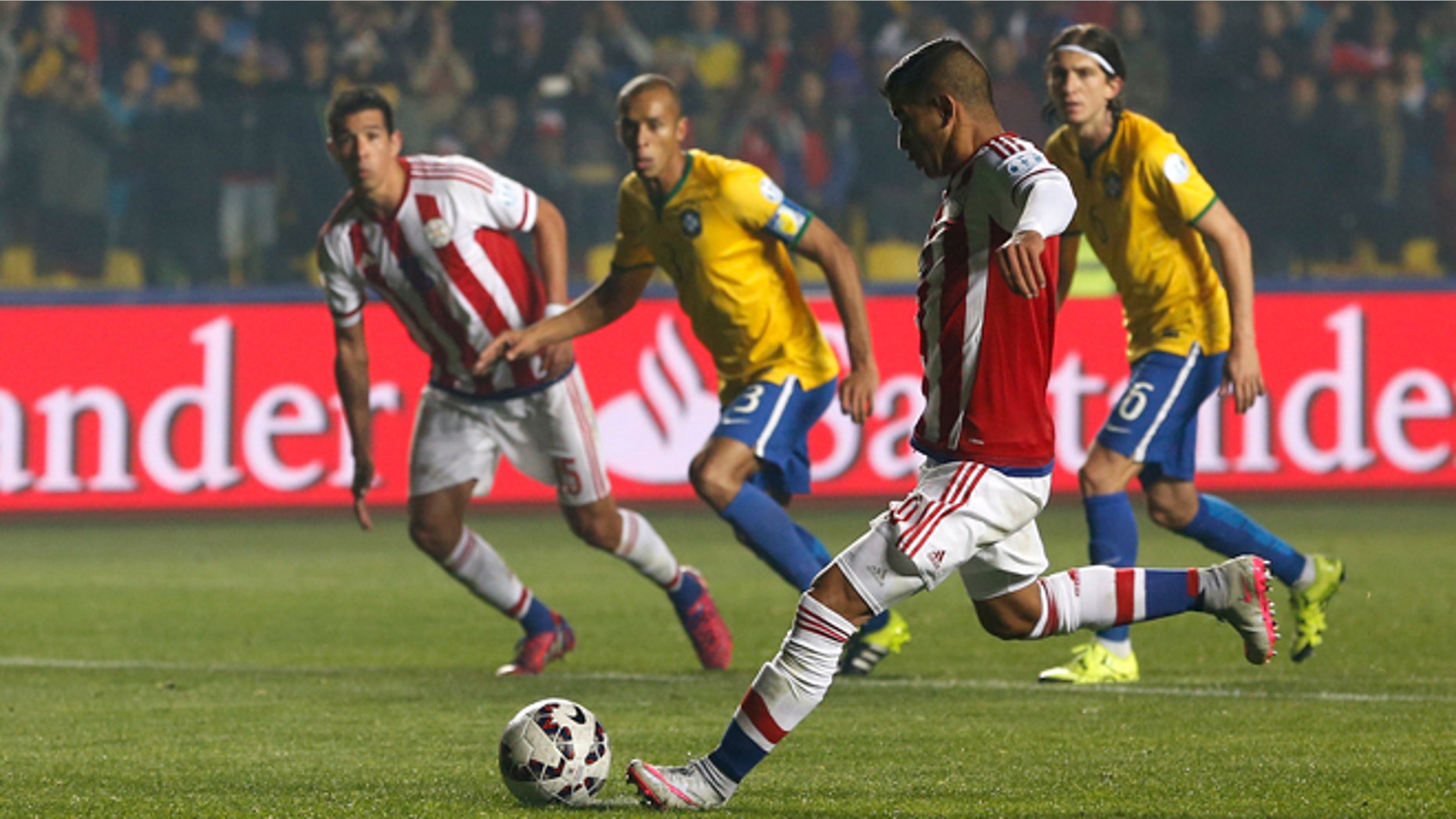 Paraguay's Derlis Gonzélez shoots from the penalty spot to scorer his sides first goal during a Copa America quarterfinal soccer match against Brazil at the Ester Roa Rebolledo Stadium in Concepción, Chile, Saturday, June 27, 2015. (AP Photo/Silvia Izquierdo)