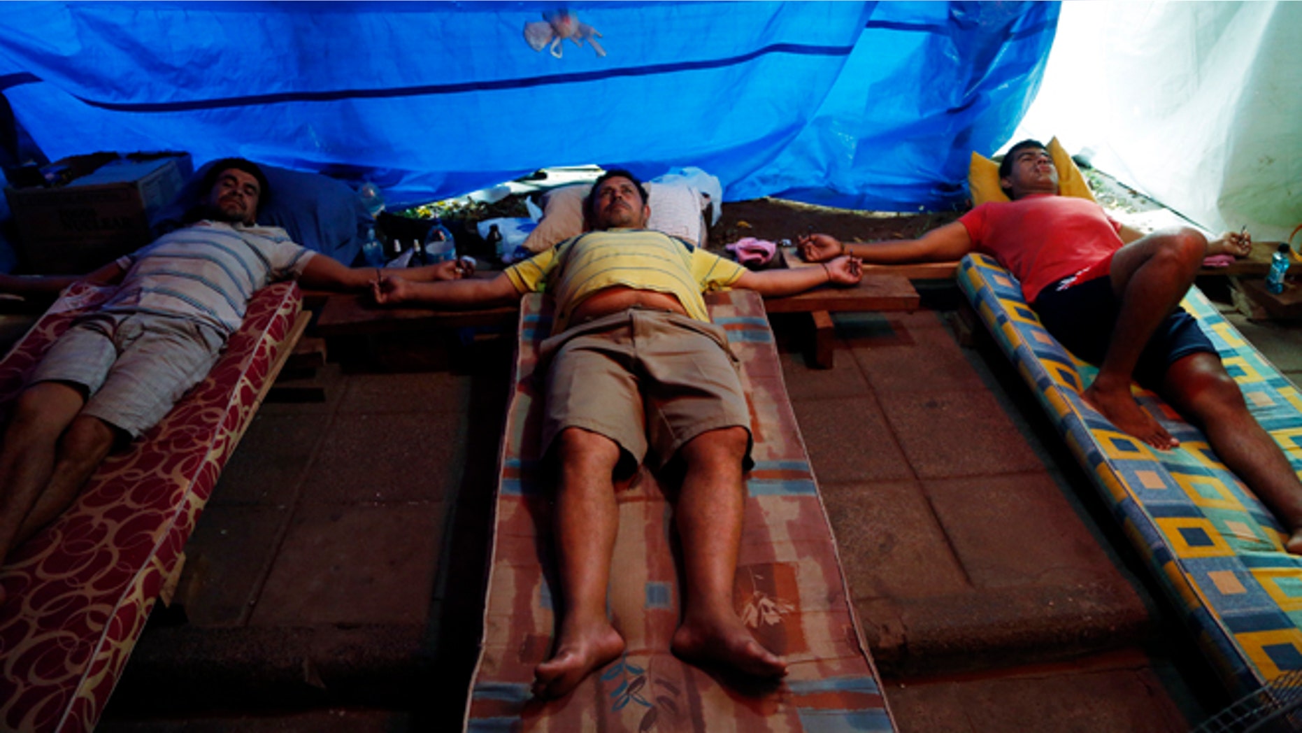 Elvio Cristaldo, Eligio Martinez and Clemente Lovera during a hunger strike in San Lorenzo, Paraguay, Sept. 10, 2014.