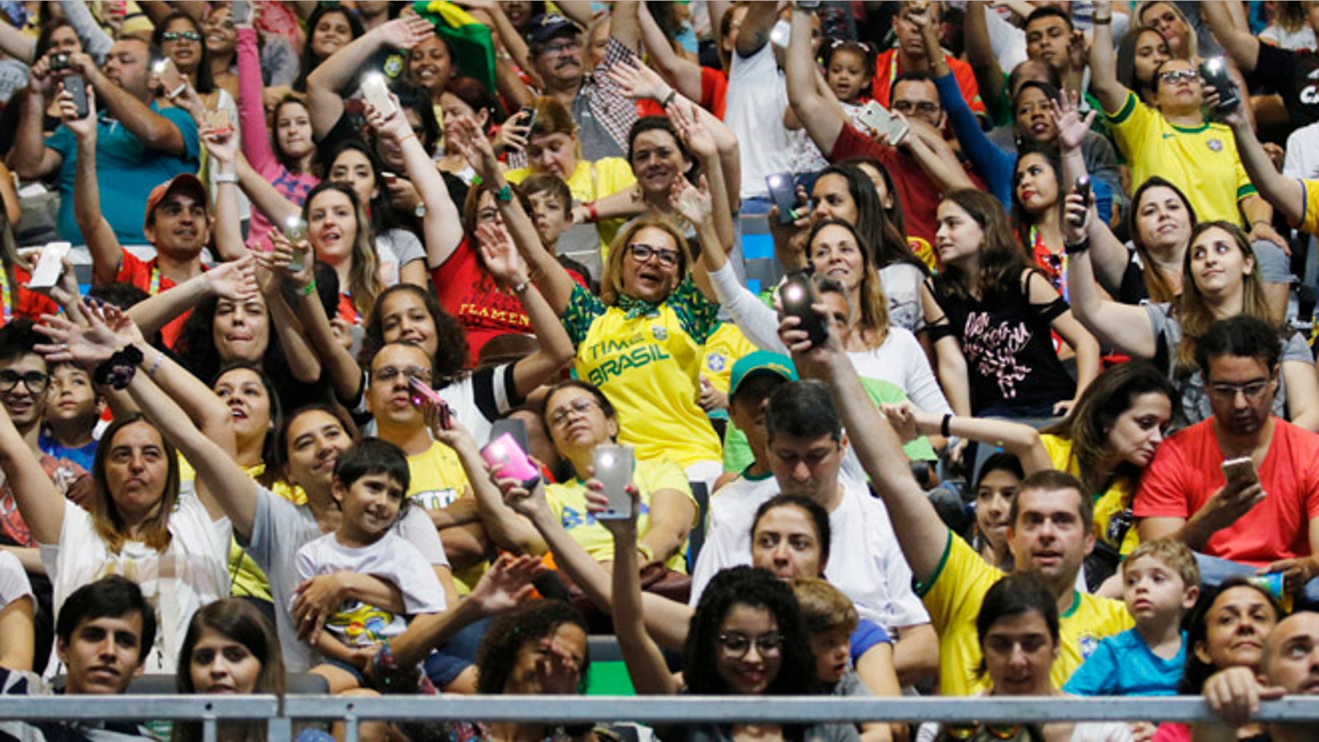 Spectators dance and cheer during the women's sitting volleyball preliminary game between Iran and the USA at the 2016 Paralympic Games in Rio de Janeiro, Brazil, Saturday, Sept. 10, 2016. Total ticket sales now sit at 1,863,000, the second-highest Paralympic Games total ever, behind London. (Jenn Finch/University of Georgia via AP)