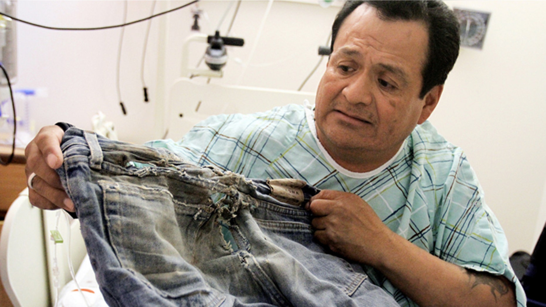 Oct. 23, 2012: Ricky Gilmore, 49, shows the pair of pants he was wearing when he dragged himself four miles down a road for three days last week near Tocito, N.M. after a man and woman he met while he was hitchhiking left him without his wheelchair in Farmington, N.M.