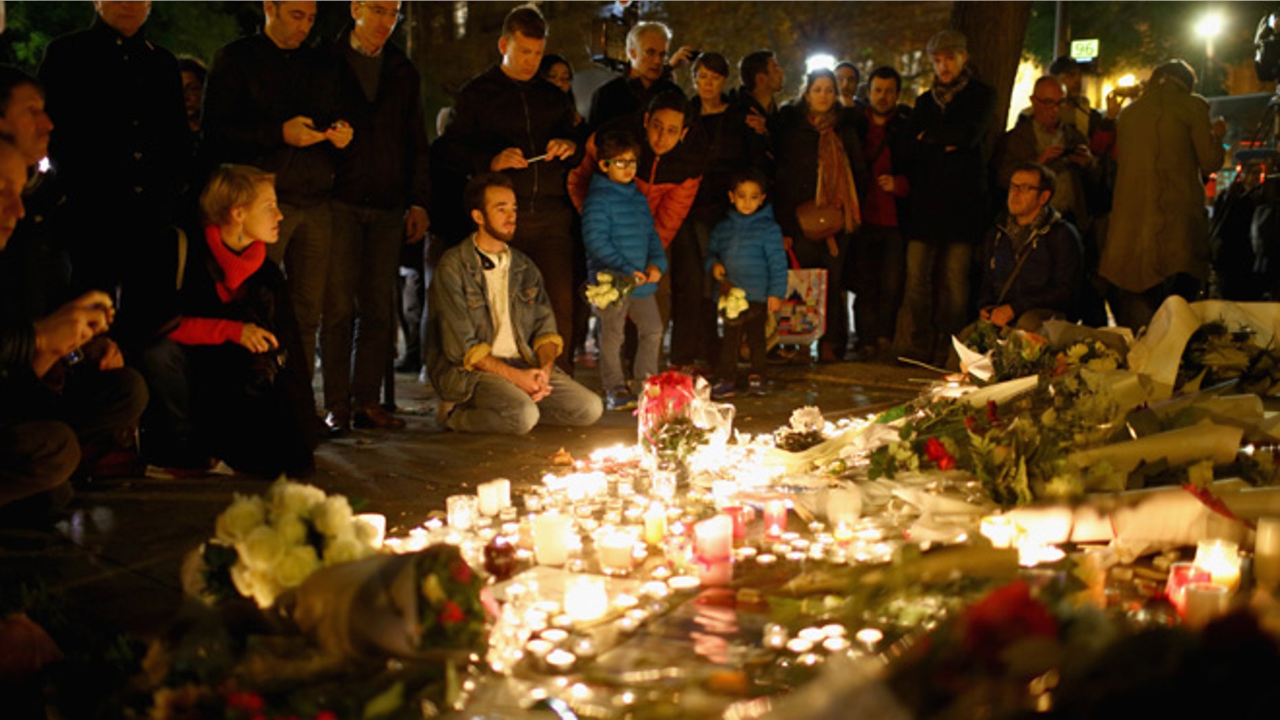PARIS, FRANCE - NOVEMBER 14: Flowers and candles are left on the pavement near the scene of yesterday's Bataclan Theatre terrorist attacks on November 14, 2015 in Paris, France. At least 120 people have been killed and over 200 injured, 80 of which seriously, following a series of terrorist attacks in the French capital. (Photo by Christopher Furlong/Getty Images)