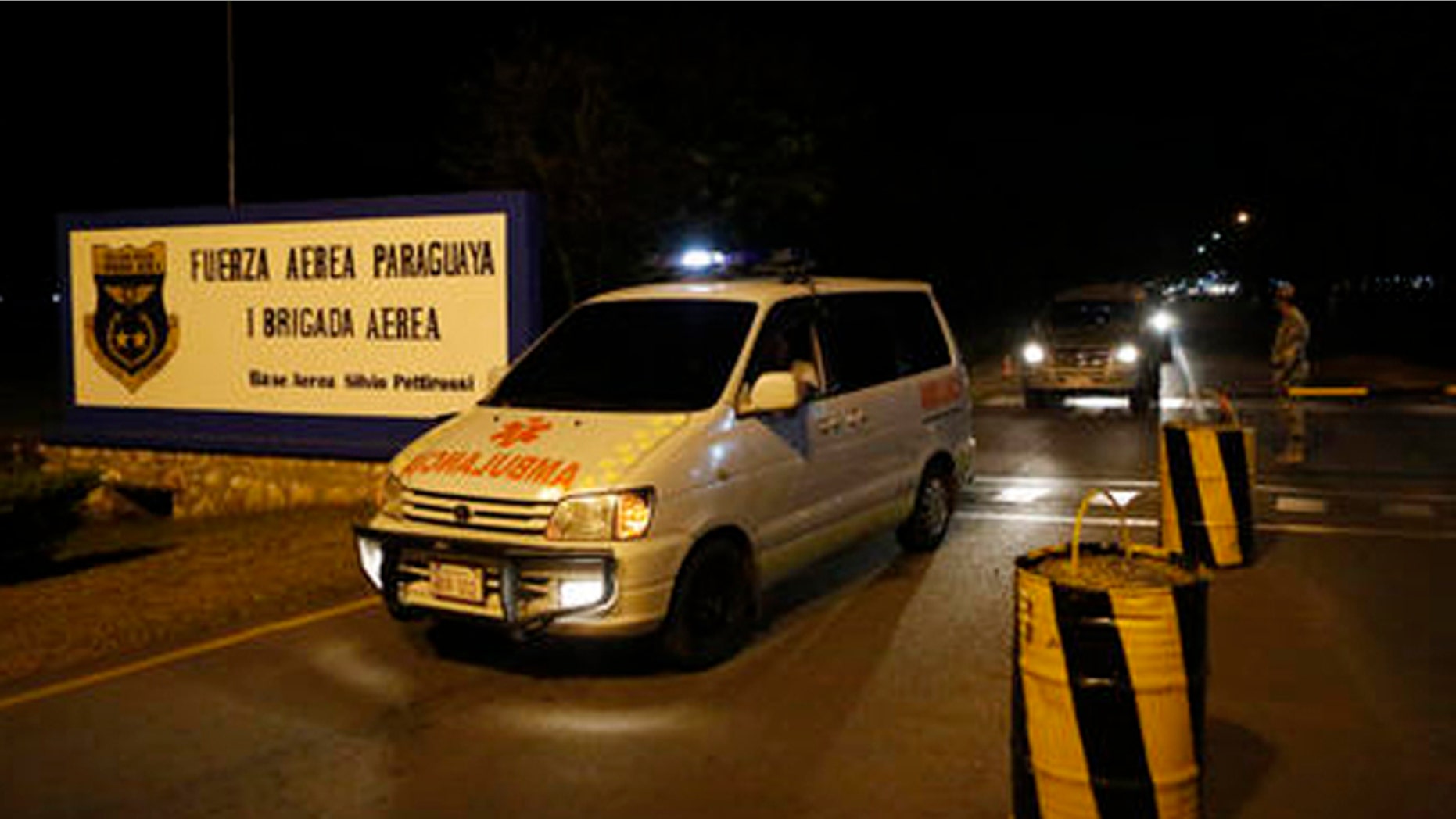 Ambulances transport the coffin of one of Paraguay's army soldiers killed in an attack on Saturday, Aug. 27, 2016, in Arroyito at asuncion airport, Paraguay. Suspected members of a little-known Paraguayan guerrilla group killed multiple soldiers in the attack in Arroyito. (AP Photo/Jorge Saenz)