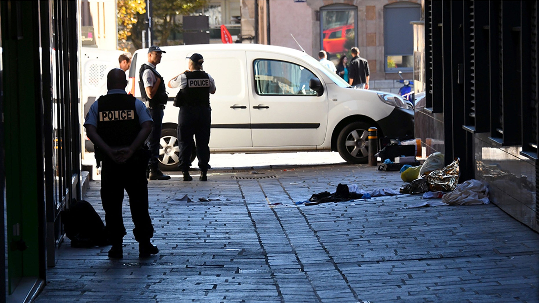 Police investigate at the site where Pascal Filoe was stabbed to death.