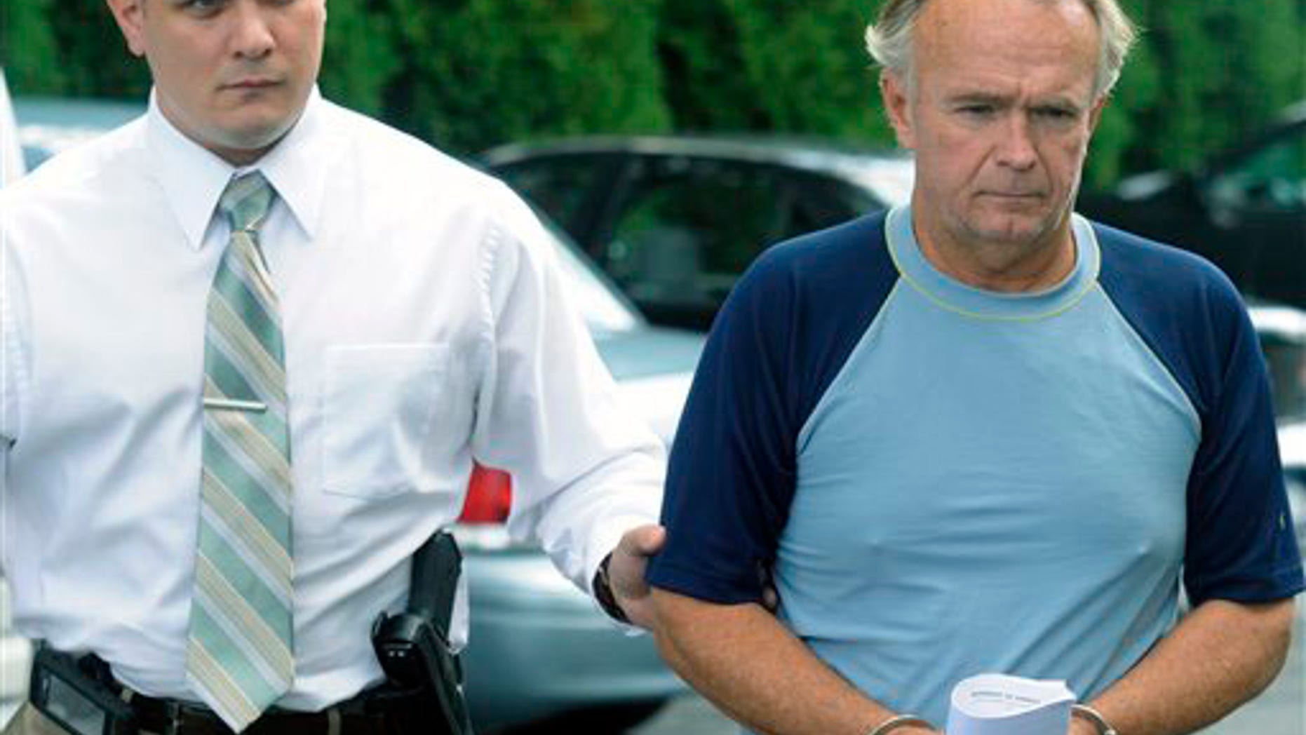 The Rev. Arthur Burton Schirmer, 62, right, is led into district court by Pennsylvania State Trooper Bill Skotleski in Tannersville, Pa., on Monday, Sept. 13, 2010. Schirmer is accused of killing his wife and staging a car accident in July 2008 to cover up the murder.