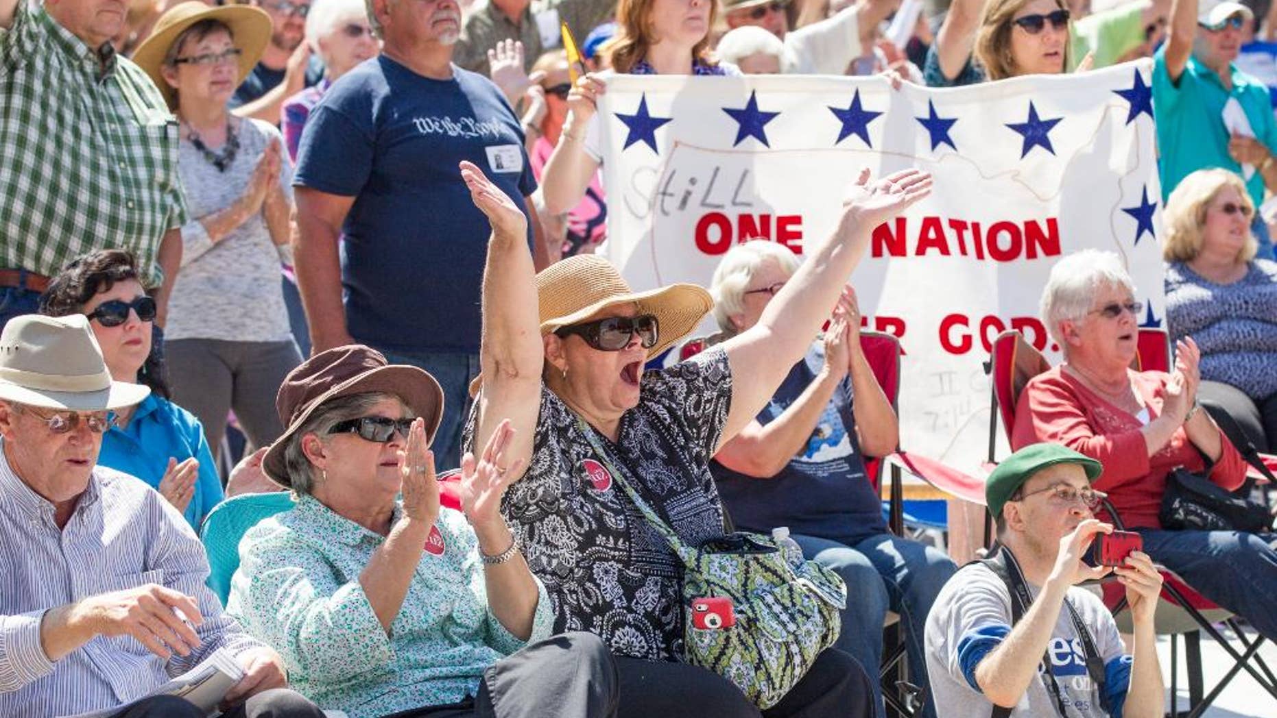 Members of the crowd cheer during a Christian conservatives rally outside the Tennessee Capitol on Thursday, Sept. 17, 2015, in Nashville. The event featured Joe Davis, the husband of Kentucky clerk Kim Davis, and Rafael Cruz, the father of U.S. Sen. Ted Cruz, a Republican presidential candidate. (AP Photo/Erik Schelzig)