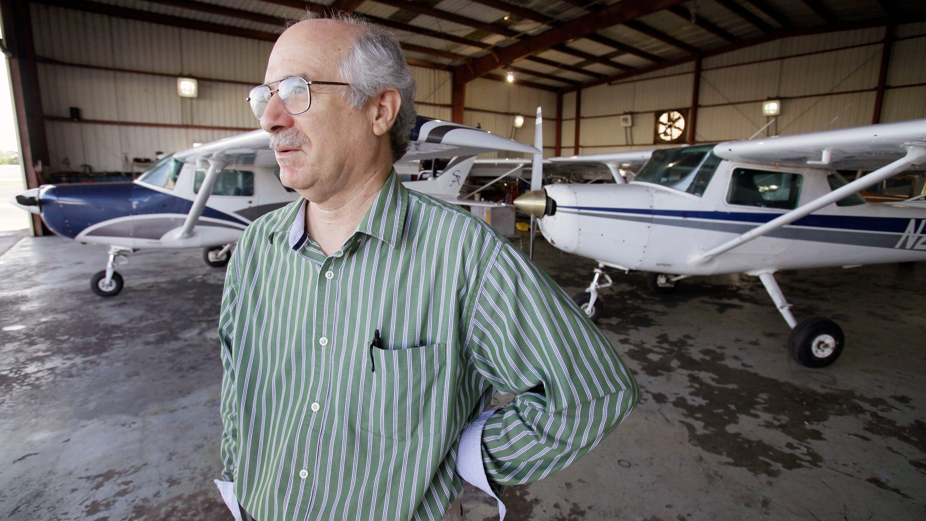 August 24: Patrick Murphy, Director of Training, looks out on the flight line from a hangar, at the Sunrise Aviation flight school in Ormond Beach, Fla. Ten years after the 9/11 attacks, government screening has made it harder for foreign students to enroll in civilian flight schools like a handful of the hijackers had done, banking on America being inviting and a place to learn quickly.