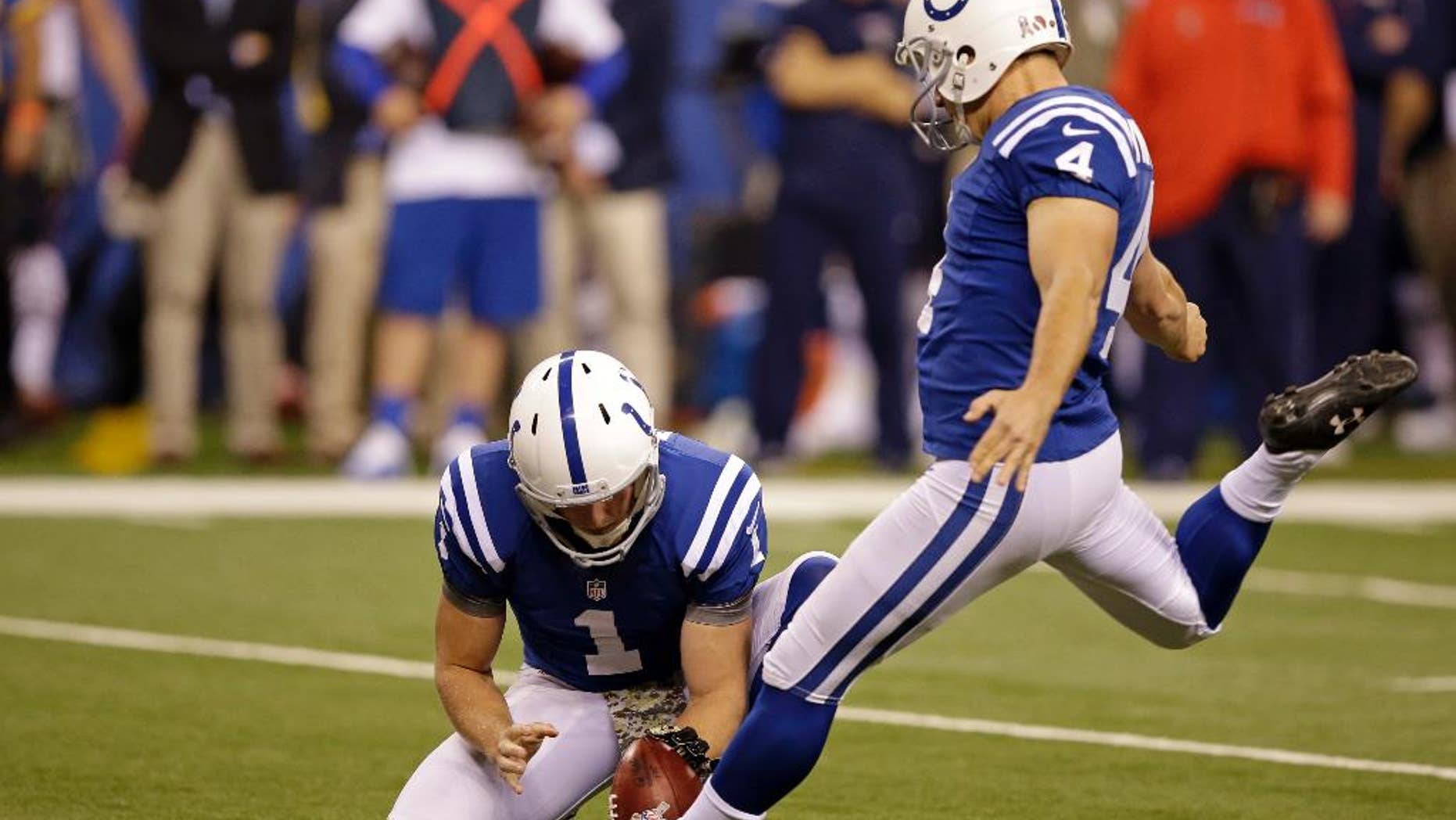 Indianapolis Colts kicker Adam Vinatieri kicks a field goal from the hold of Pat McAfee during the first half of an NFL football game against the New England Patriots in Indianapolis, Sunday, Nov. 16, 2014. (AP Photo/Darron Cummings)