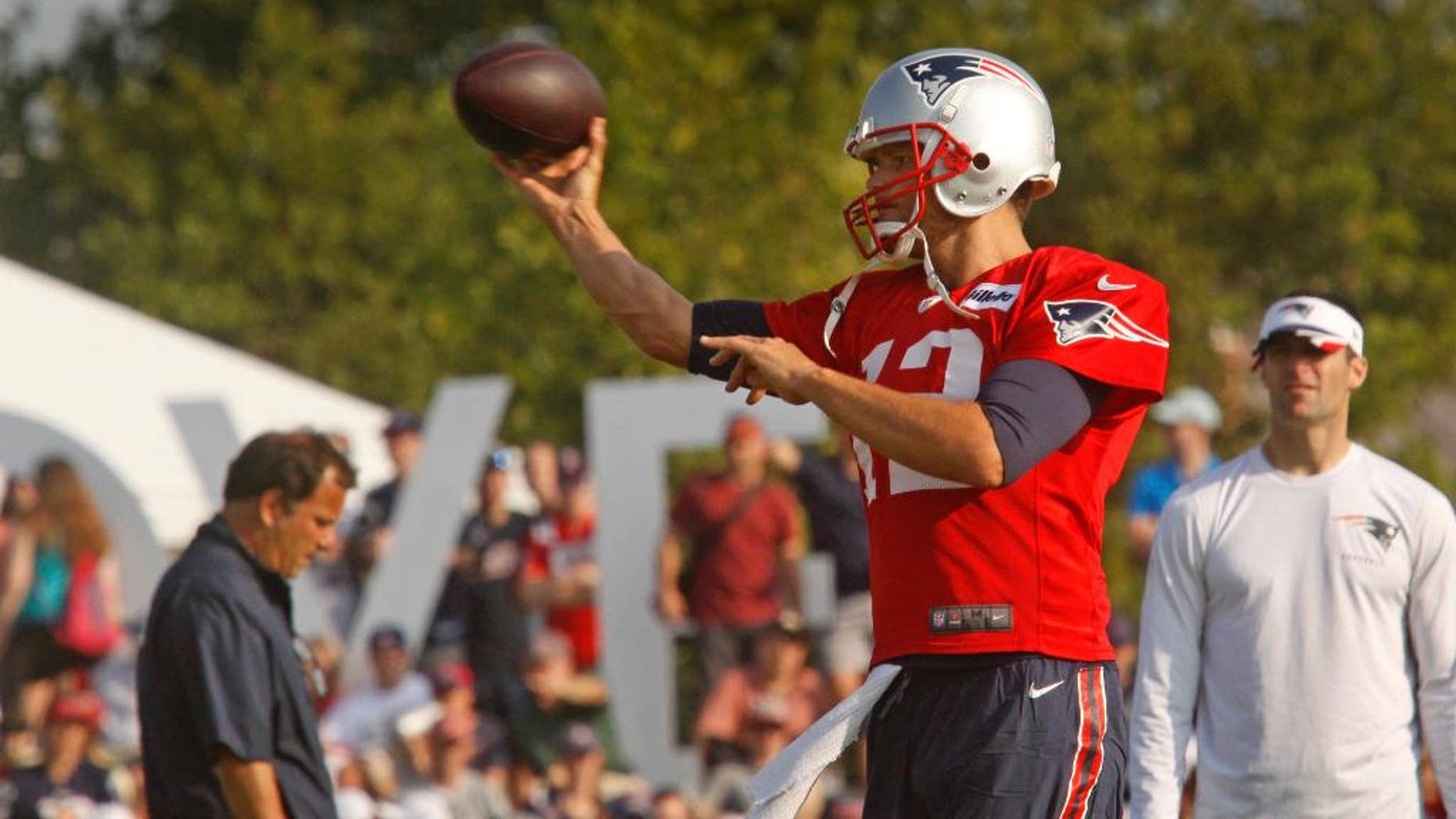 New England Patriots NFL teams quarterback Tom Brady (12) throws during a joint training camp with the Washington Redskins in Richmond, Va., Wednesday, Aug. 6, 2014. (AP Photo/Jay Paul)