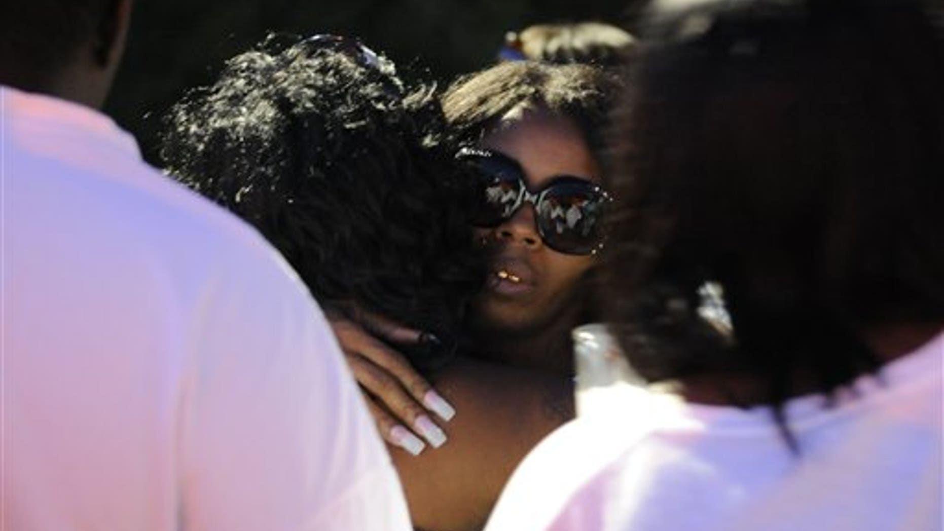 Aug. 6, 2012: Teresa Carter, mother of Chavis Carter, is hugged by supporters following the candlelight vigil held in her son's honor at the First Baptist Church on Kitchen Street in Jonesboro, Ark.