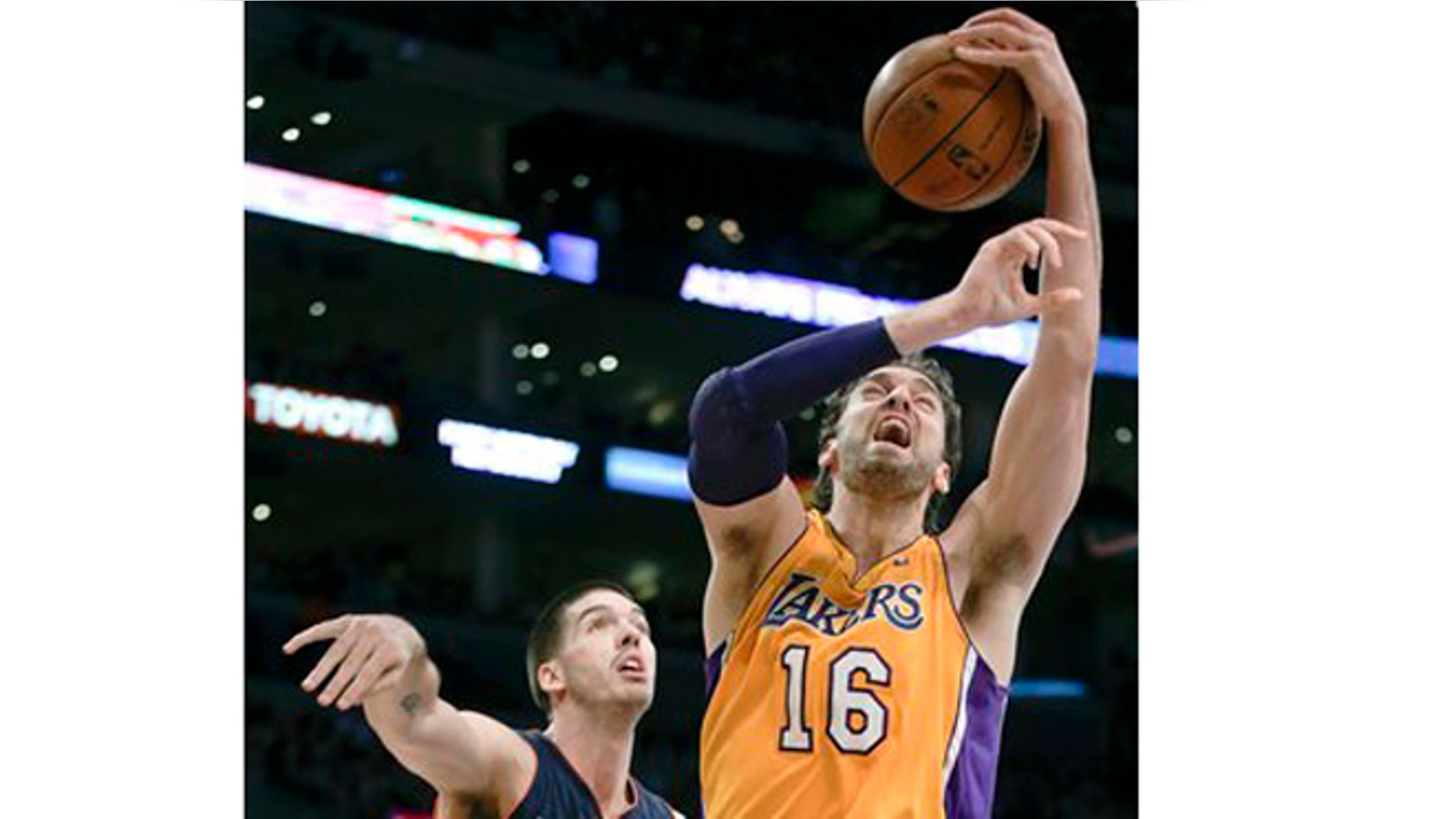 Los Angeles Lakers forward Pau Gasol, right, is fouled by Charlotte Bobcats center Byron Mullens during the first half of an NBA basketball game in Los Angeles, Tuesday, Dec. 18, 2012. (AP Photo/Chris Carlson)