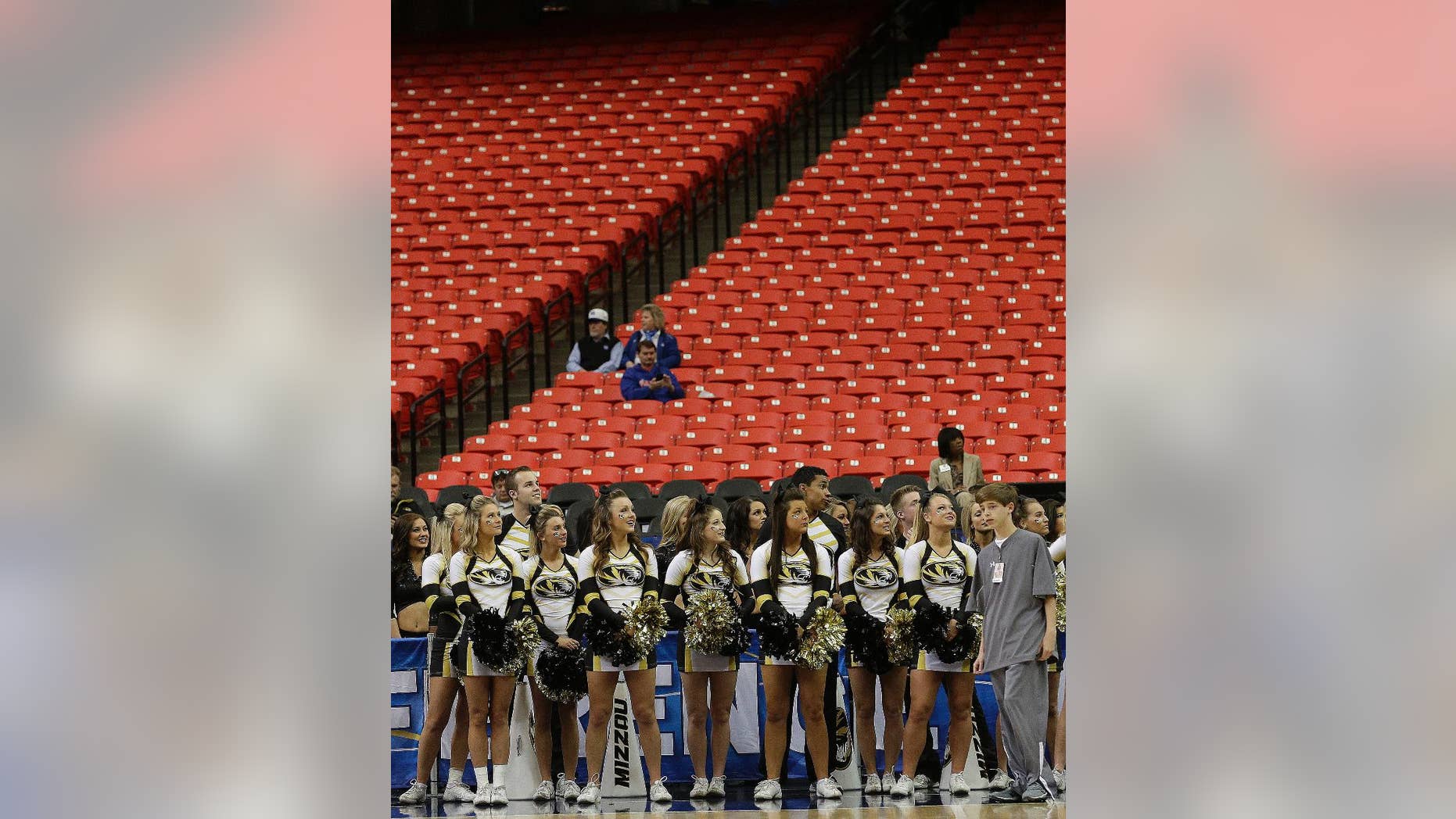 Missouri cheerleaders watch the floor during the first half of an NCAA college basketball game against Florida in the quarterfinal round of the Southeastern Conference men's tournament, Friday, March 14, 2014, in Atlanta. With rivalries in tatters, league alignments all messed up, and tens of thousands of empty seats, it might be time to reassess the need for conference tournaments. (AP Photo/Steve Helber)