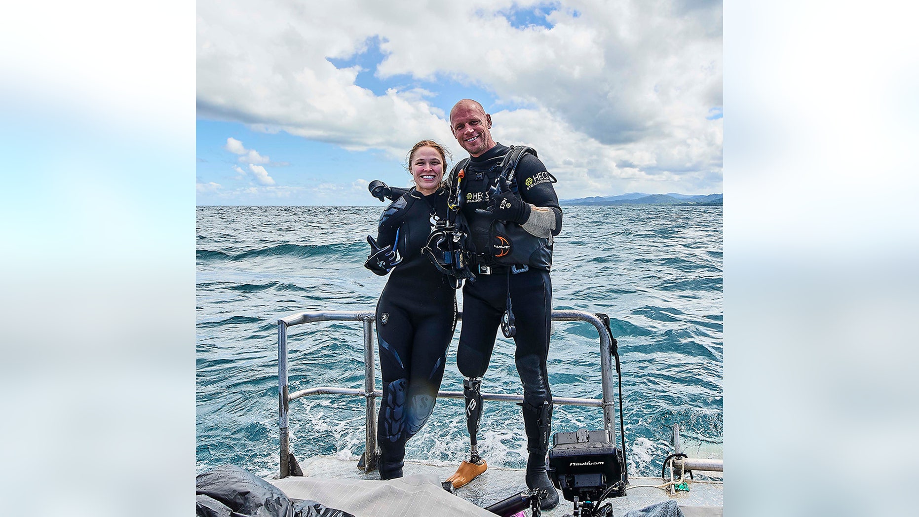 Ronda Rousey and Paul de Gelder pose before their dive beneath the waters off the Fiji coast. "Ronda Rousey Uncaged" airs Monday, as part of Discovery Channel's annual Shark Week.