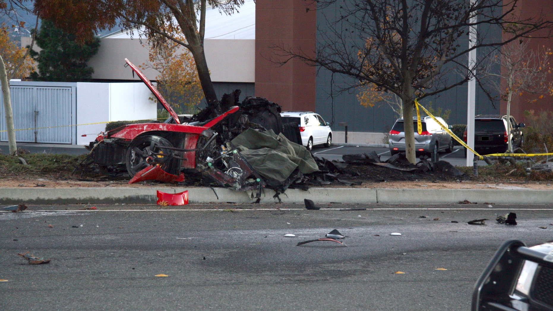 Nov. 30, 2013: The wreckage of a Porsche that crashed into a light pole in Valencia, Calif, killing Paul Walker and Roger Rodas.