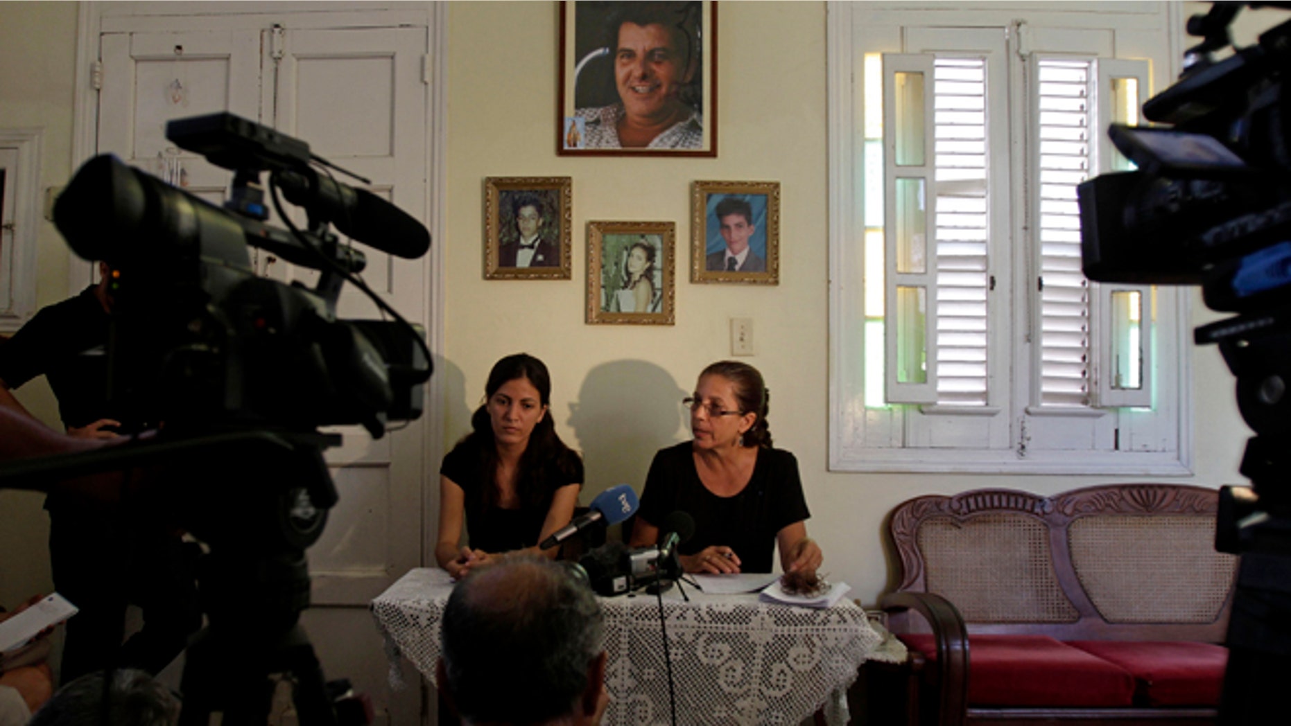 Ofelia Acevedo, right, widow of the late Cuban activist Oswaldo Paya and her daugther Rosa Maria Paya hold a news conference, in Havana, Cuba, Wednesday, Aug 1, 2012. Cuba has charged a Spanish citizen with the equivalent of vehicular manslaughter in the July 22 car accident that killed Acevedo's husband, a prominent dissident and another government opponent. (AP Photo/Franklin Reyes)