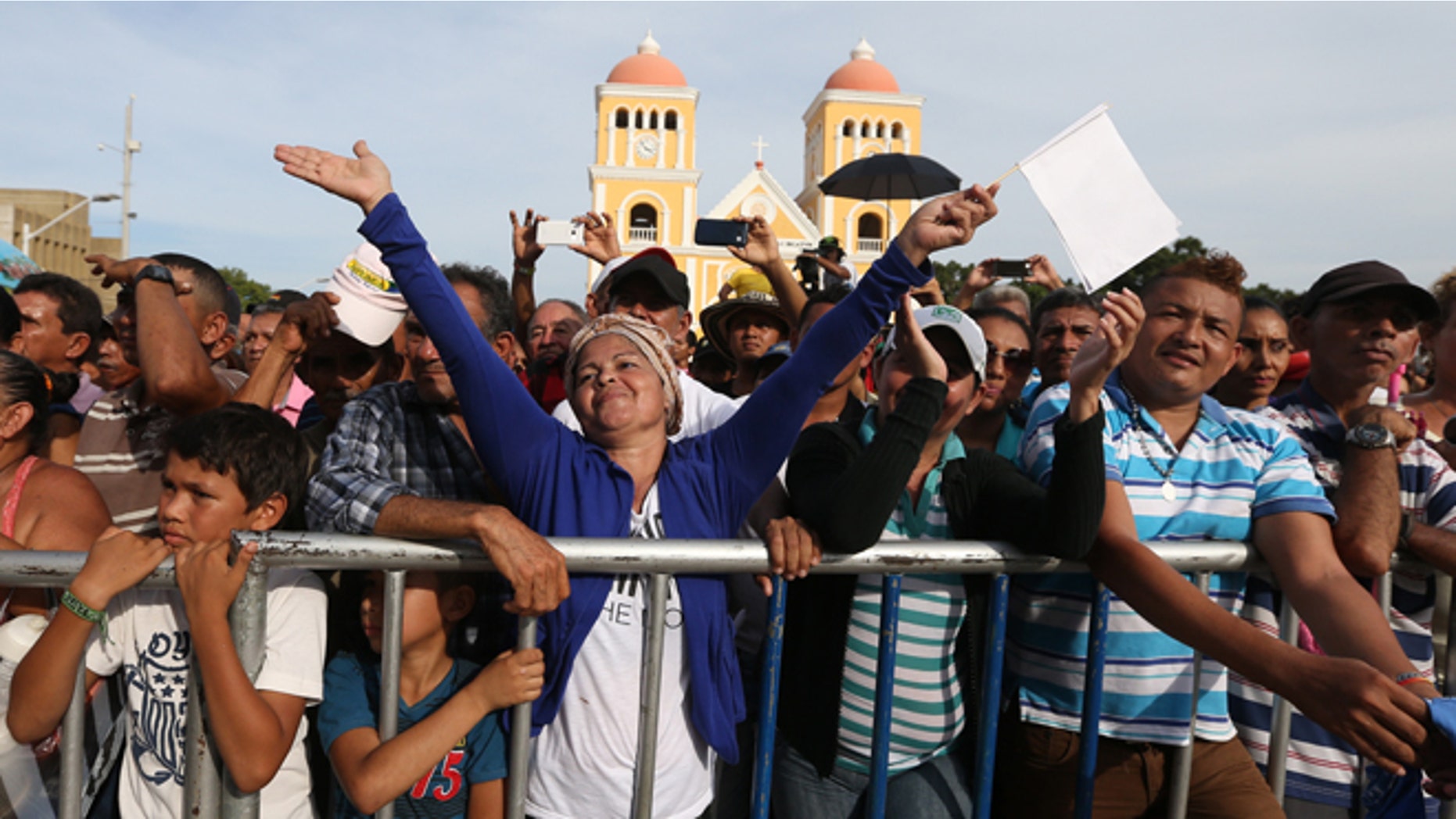 People enjoy a concert for peace in Carmen de Bolivar, Colombia, Sunday, Sept. 25, 2016. Colombia's government and the Revolutionary Armed Forces of Colombia, FARC, will sign a peace agreement to end over 50 years of conflict, in Cartagena, on Monday. (AP Photo/Fernando Vergara)