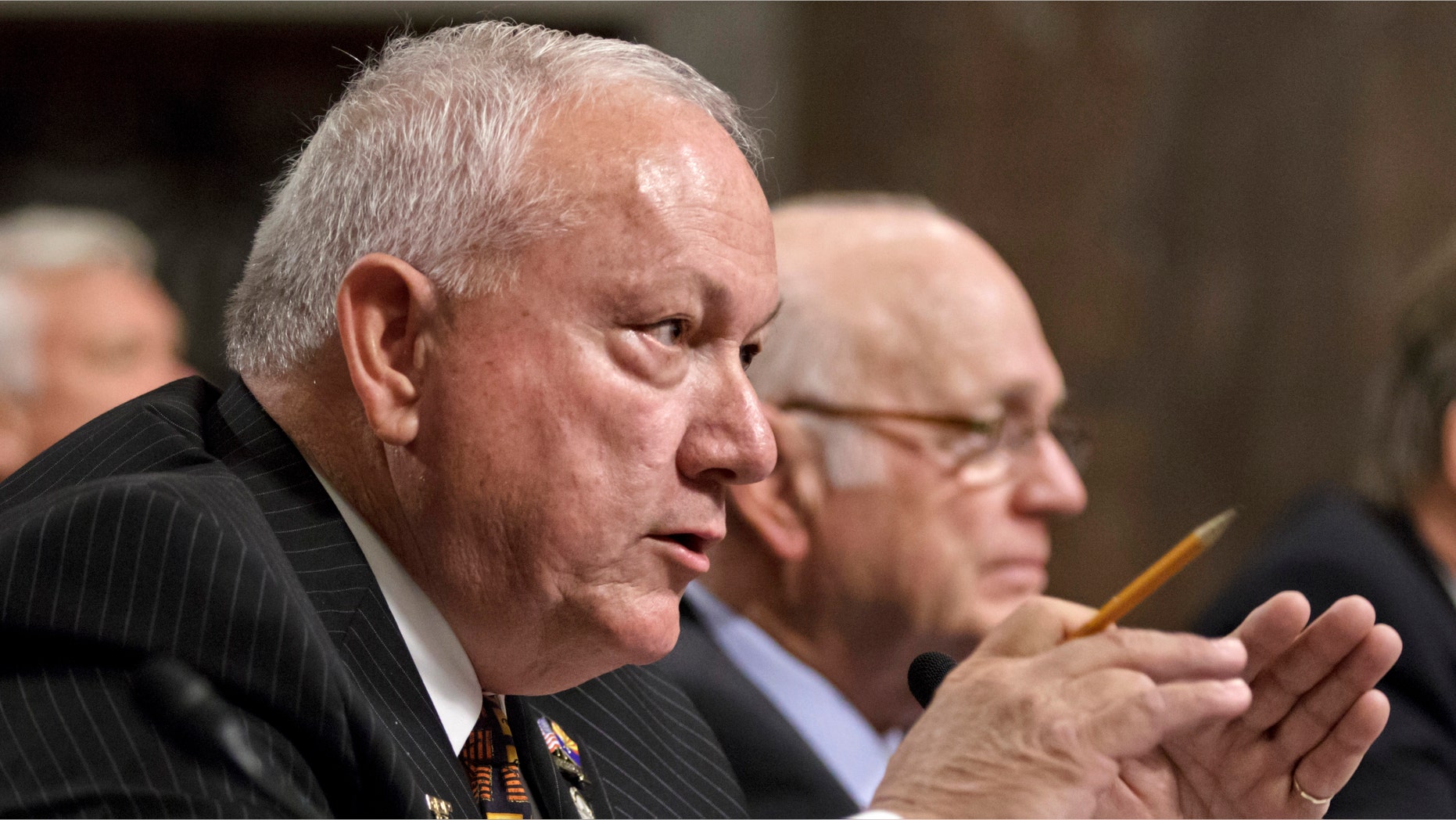 Former Arizona state Sen. Russell Pearce, the architect of Arizona's controversial immigration law S.B. 1070, left, accompanied by former Arizona Sen. Dennis DeConcini, testifies on Capitol Hill in Washington, Tuesday, April 24, 2012, before the Senate Immigration, Refugees and Border Security subcommittee hearing entitled "Examining the Constitutionality and Prudence of State and Local Governments Enforcing Immigration Law." The Supreme Court will referee another major clash between the Obama administration and the states Wednesday as it hears arguments over Arizona's crackdown on illegal immigrants. (AP Photo/J. Scott Applewhite)