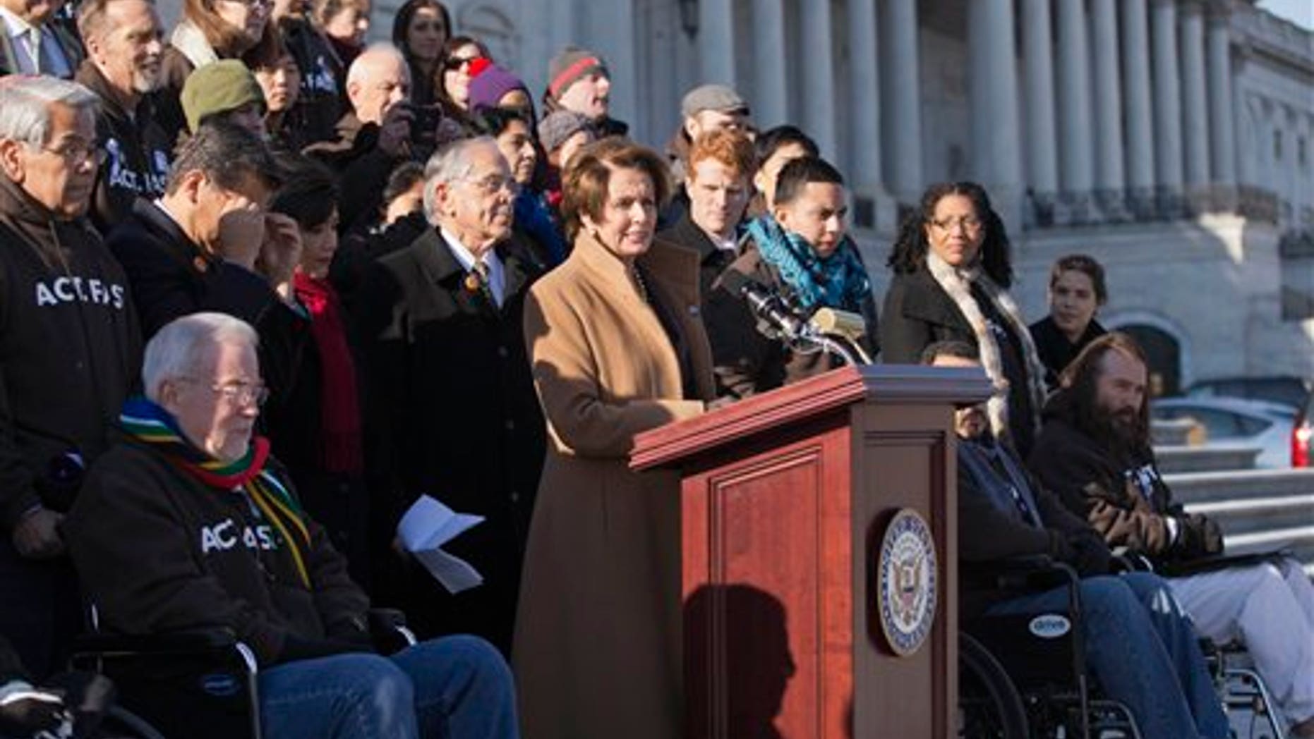 FILE - In this Dec. 12, 2013, file photo House Minority Leader, Democrat Nancy Pelosi of California, at the podium, is joined by Congressional Hispanic Caucus Chairman Rep. Ruben Hinojosa, D-Texas, to her left, as she calls for action on immigration reform on Capitol Hill in Washington with other lawmakers and activists. Democrats are planning to rely on an infrequently used and rarely successful tactic to shine an election-year spotlight on Republican opposition to raising the minimum wage and overhauling immigration laws: its known as a "discharge petition. It requires the minority party to persuade some two dozen Republicans to defy their leadership. (AP Photo/J. Scott Applewhite, File)
