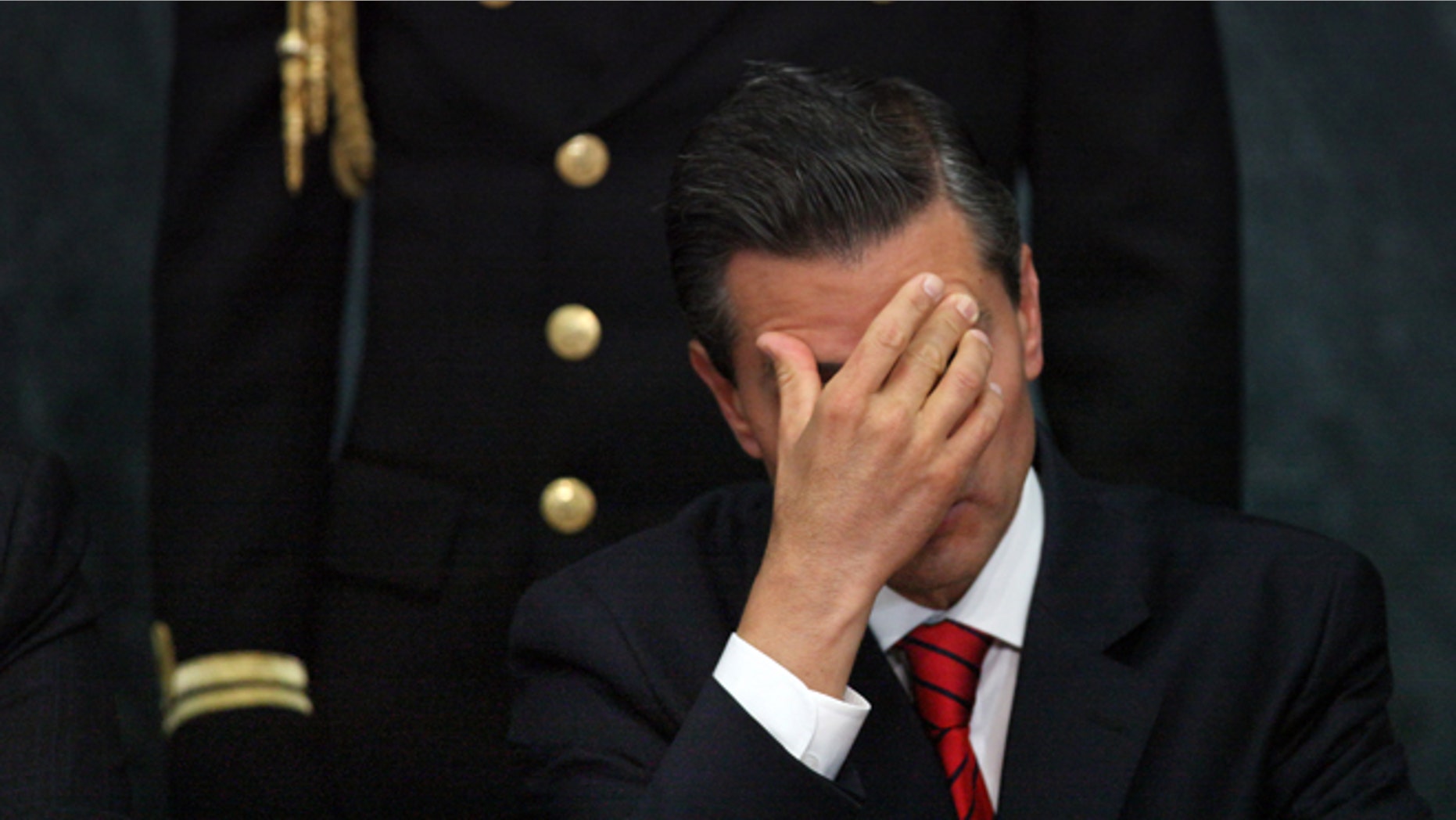 FILE - In this Wednesday, Jan. 21, 2015, file photo, Mexico's President Enrique Pena Nieto attends a ceremony promoting housing for low income families, single mothers and members of the armed forces at Los Pinos presidential residence in Mexico City. Pena Nieto has also seen his pro-business agenda derailed by allegations of corruption and the disappearance of 43 students after they were handed over by police to local drug traffickers. (AP Photo/Marco Ugarte, File)