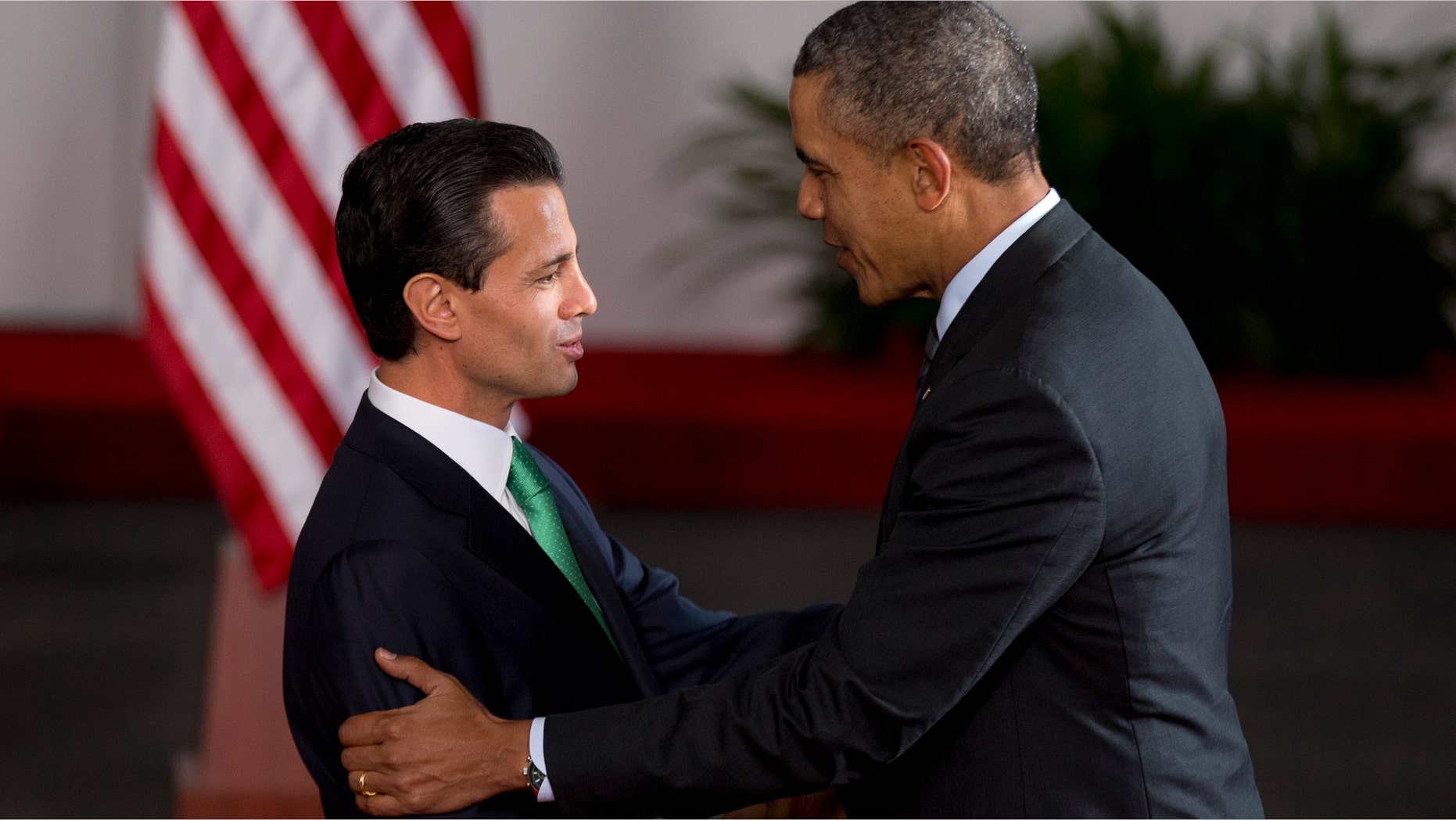 Mexico's President Enrique Pena Nieto, left, and President Barack Obama shake hands upon Obama's arrival to the North American Leaders Summit in Toluca, Mexico Wednesday, Feb. 19, 2014. Obama is in Toluca Wednesday for the one-day summit with Mexican and Canadian leaders, meeting on issues of trade and other neighbor-to-neighbor interests, even as Congress is pushing back against some of his top cross-border agenda items. (AP Photo/Eduardo Verdugo)