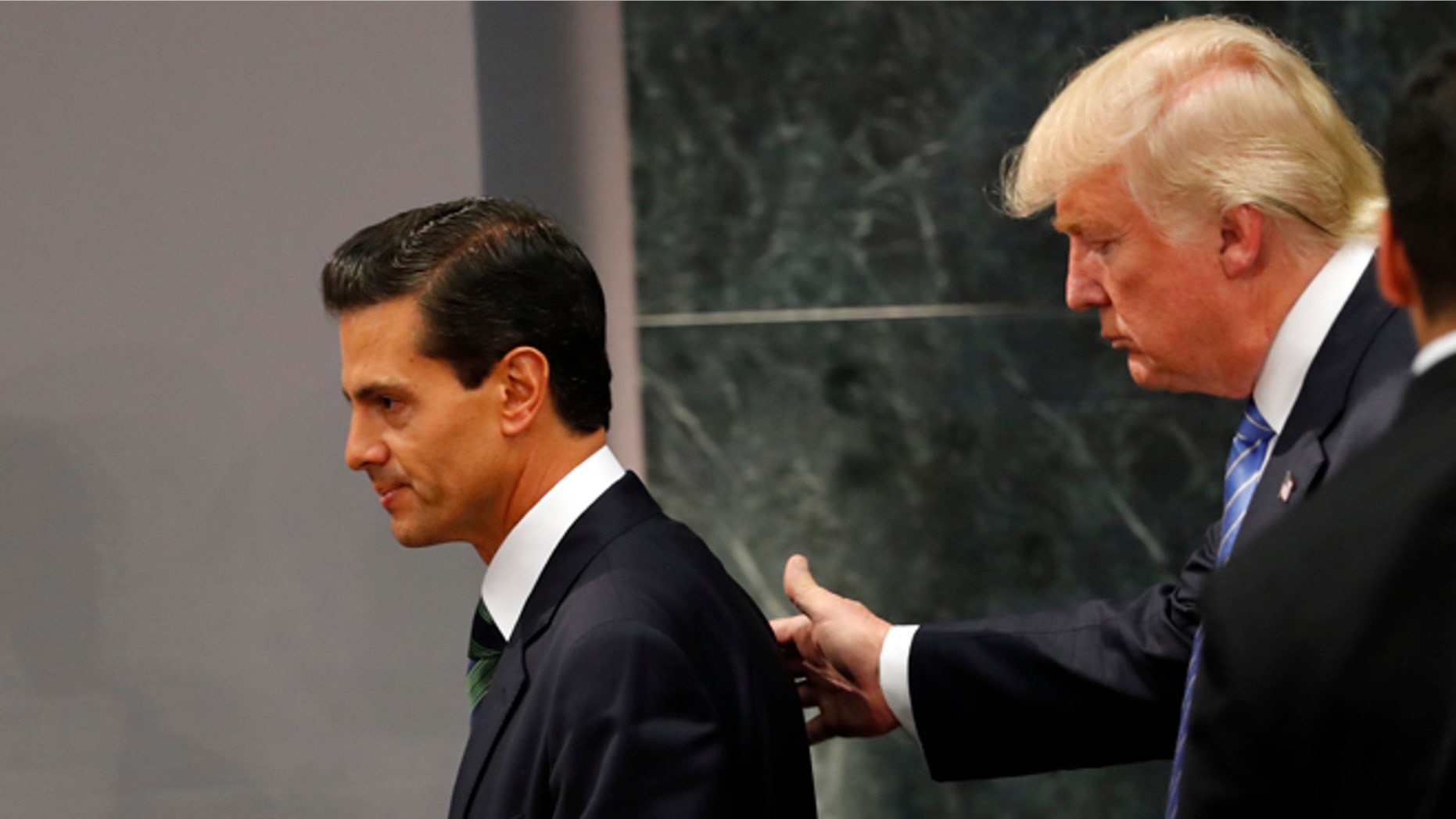 Republican presidential nominee Donald Trump walks with Mexico President Enrique Pena Nieto at the end of their joint statement at Los Pinos, the presidential official residence, in Mexico City, Wednesday, Aug. 31, 2016. Trump is calling his surprise visit to Mexico City Wednesday a 'great honor.' The Republican presidential nominee said after meeting with Peña Nieto that the pair had a substantive, direct and constructive exchange of ideas.(AP Photo/Dario Lopez-Mills)