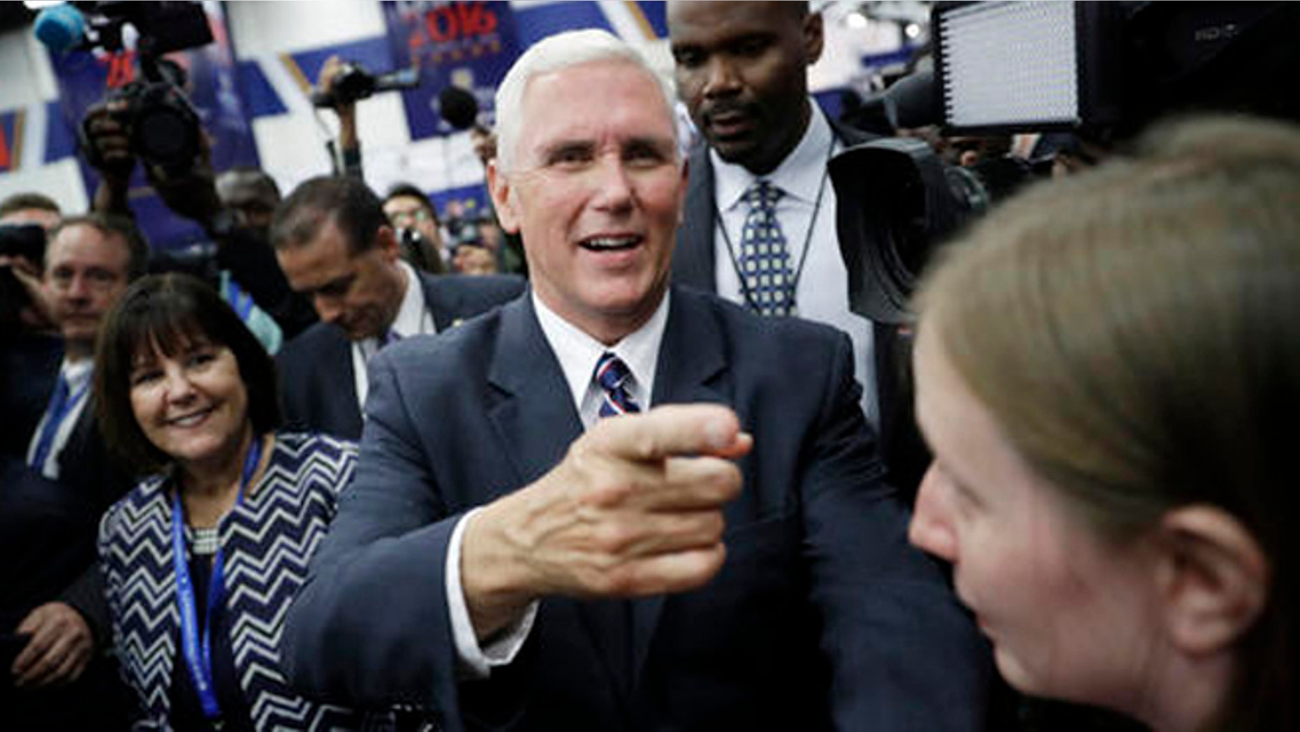 Republican vice presidential candidate Indiana Gov. Mike Pence makes his way through a crowd before the presidential debate between Democratic presidential candidate Hillary Clinton and Republican presidential candidate Donald Trump at Hofstra University in Hempstead, N.Y., Monday, Sept. 26, 2016, in Hempstead, N.Y. (AP Photo/John Locher)