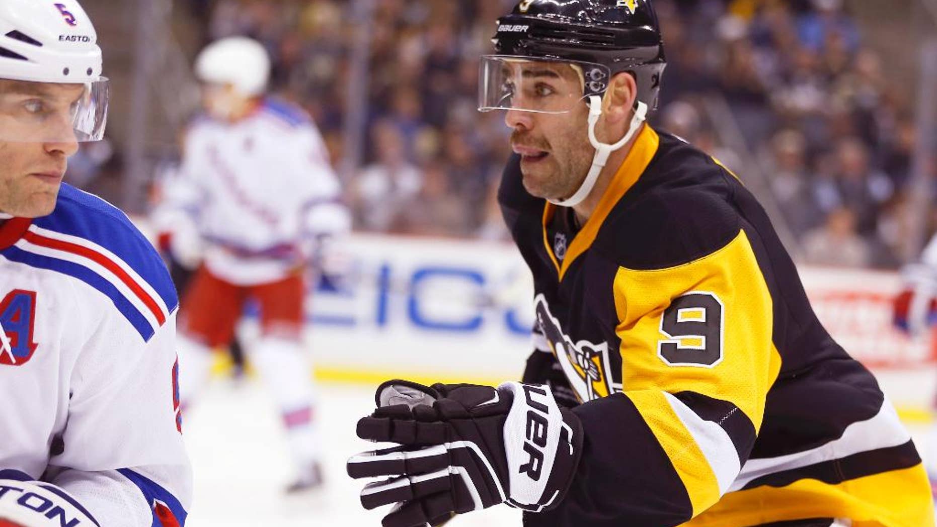 In this photo from Saturday, Nov. 15, 2014, Pittsburgh Penguins' Pascal Dupuis (9) plays against New York Rangers' Dan Girardi (5) in the second period of the NHL hockey game, in Pittsburgh. The Pittsburgh Penguins said on Wednesday, Nov. 19, 2014, that forward Dupuis is out at least six months after doctors discovered a blood clot in his lung.(AP Photo/Keith Srakocic)